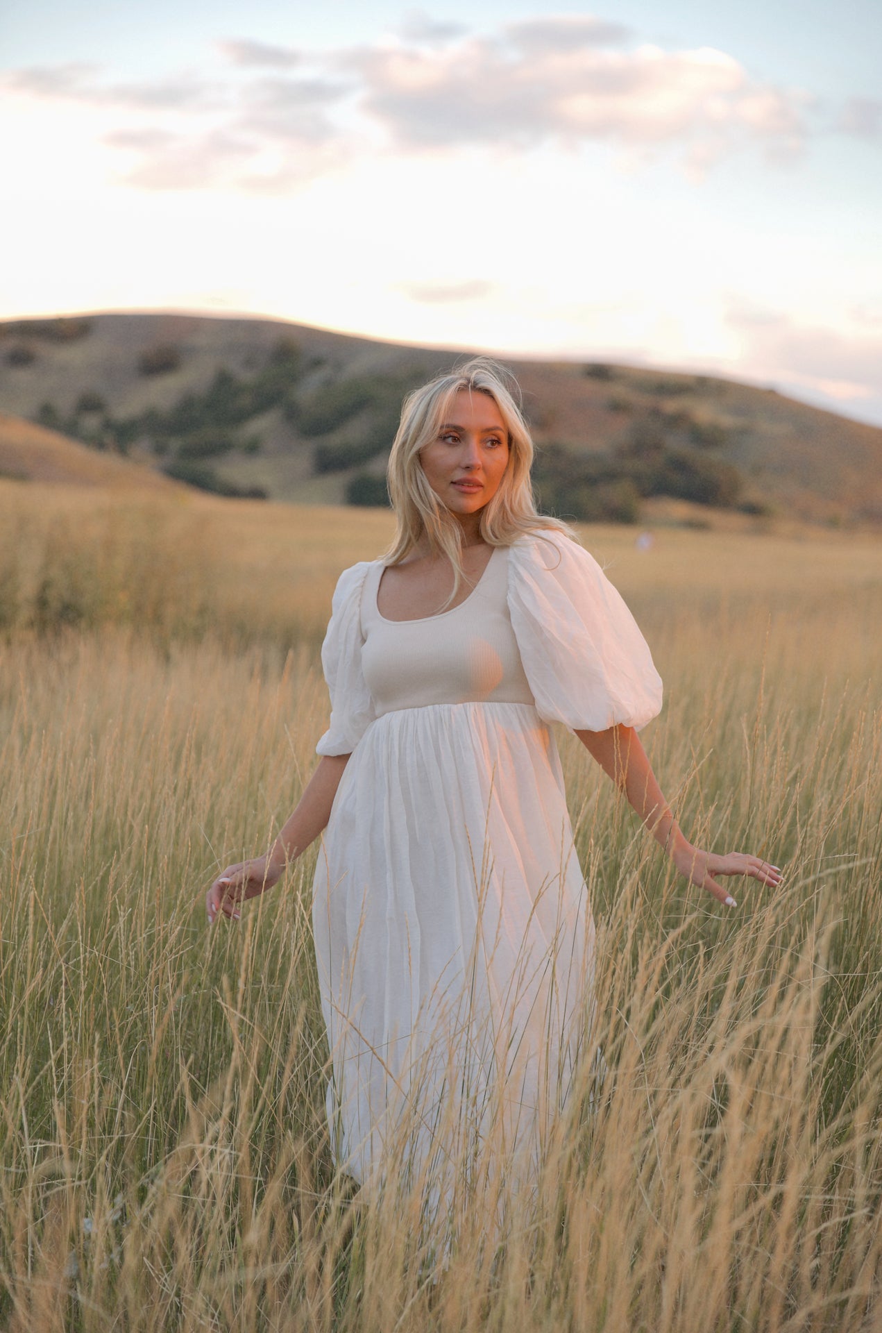 cream and white puff sleeve midi dress with a babydoll silhouette