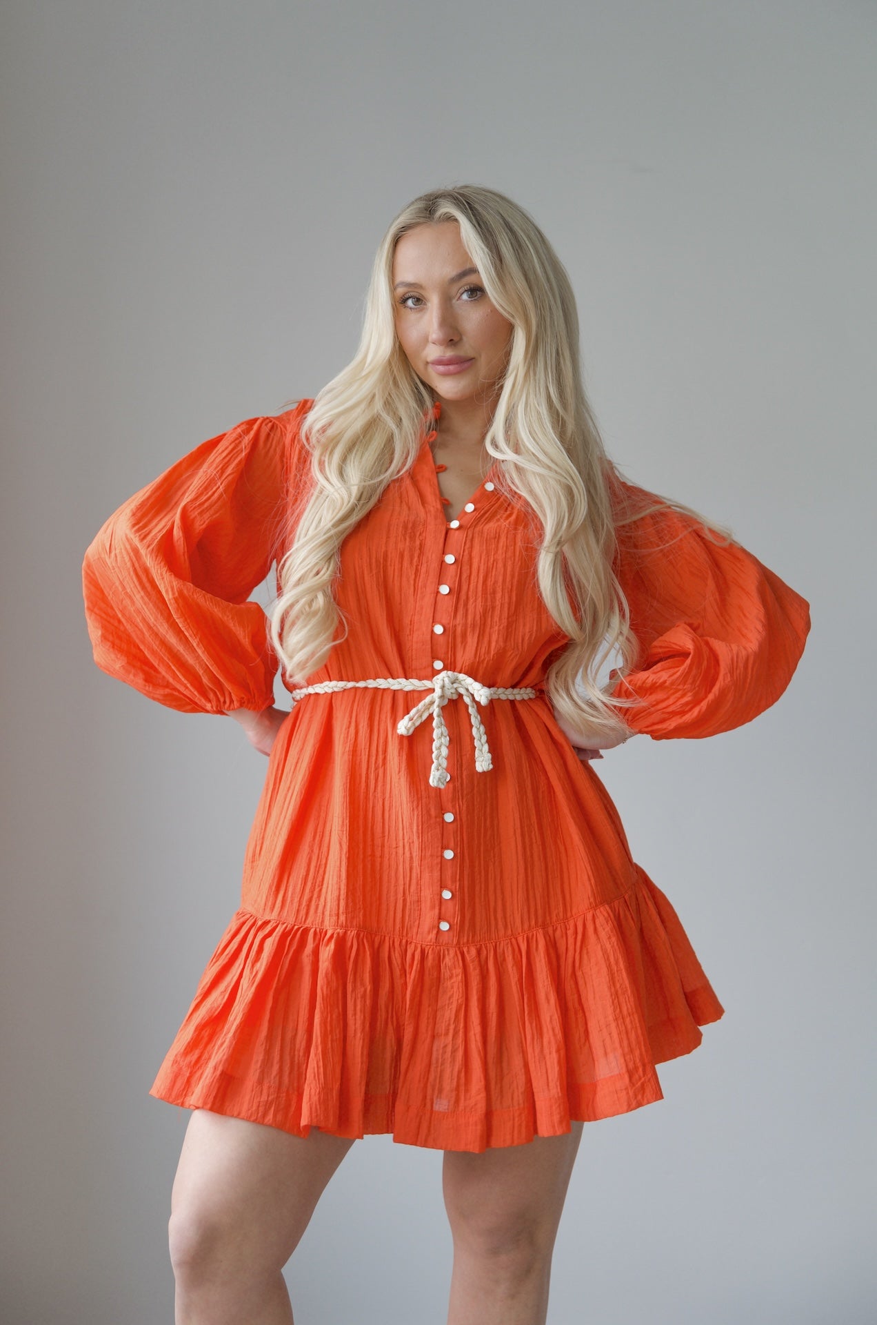orange long sleeve mini dress with a braided belt