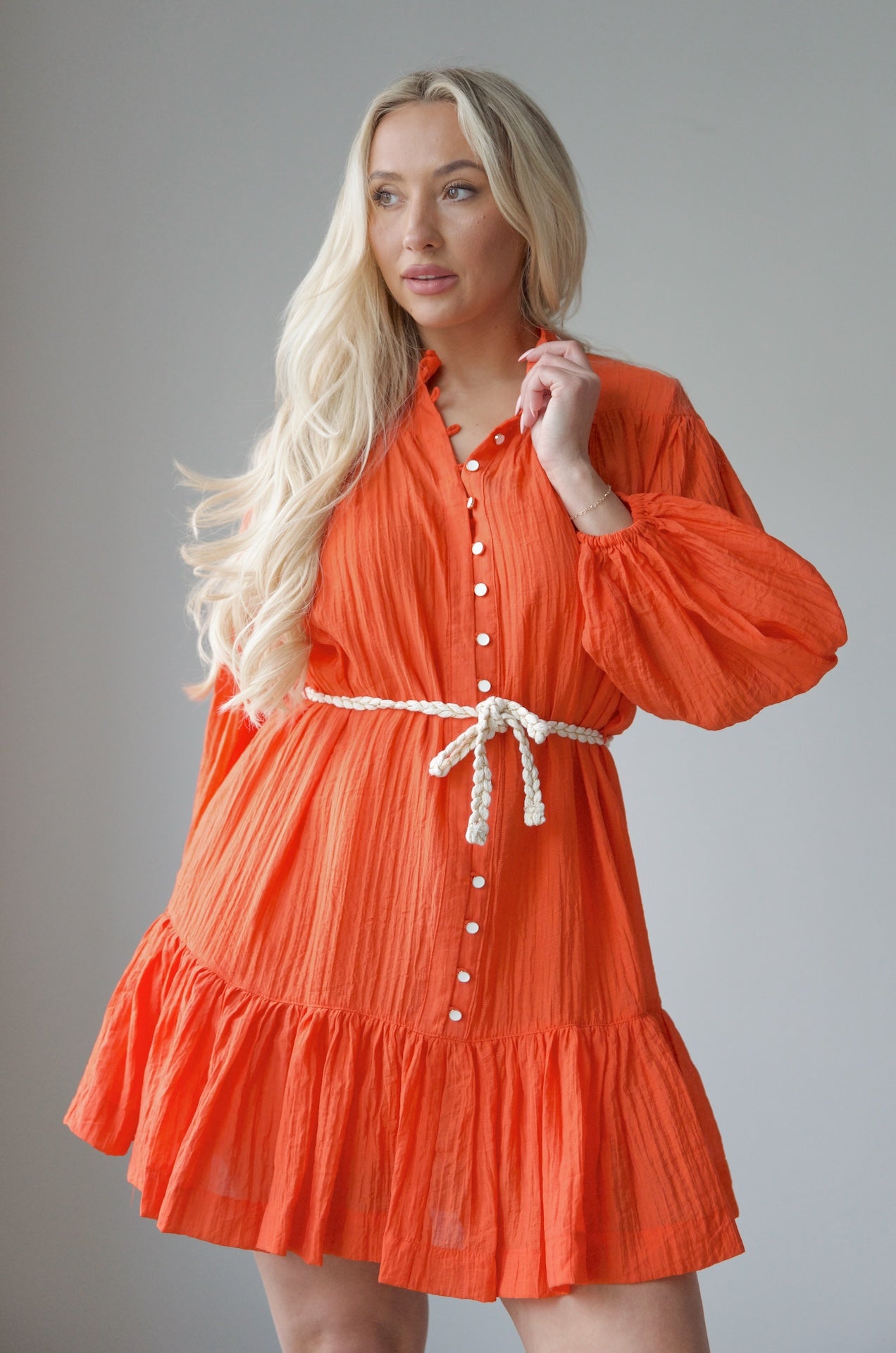 orange long sleeve mini dress with a braided belt