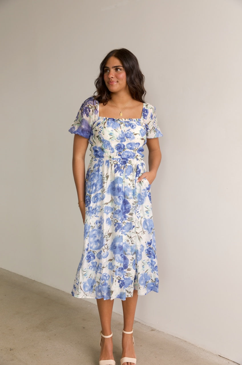 blue and white floral midi dress with puff sleeves and a square neckline