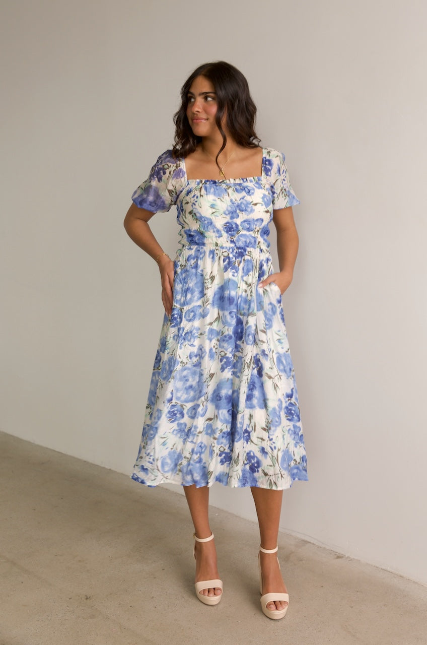 blue and white floral midi dress with puff sleeves and a square neckline