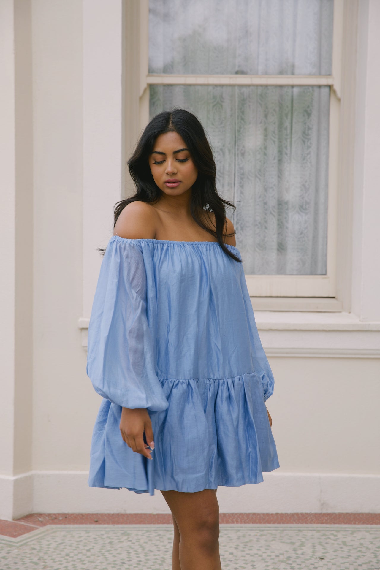 blue off the shoulder loose mini dress with puffy long sleeves and tiered skirt
