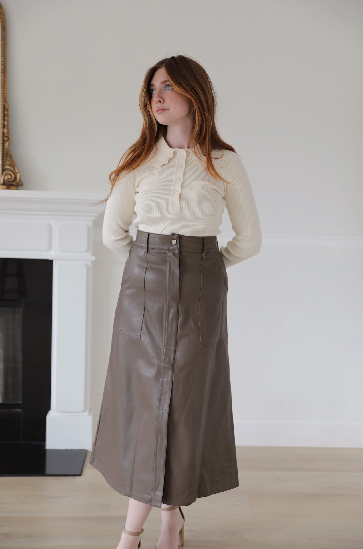 brown faux leather midi skirt that is high waisted with pockets
