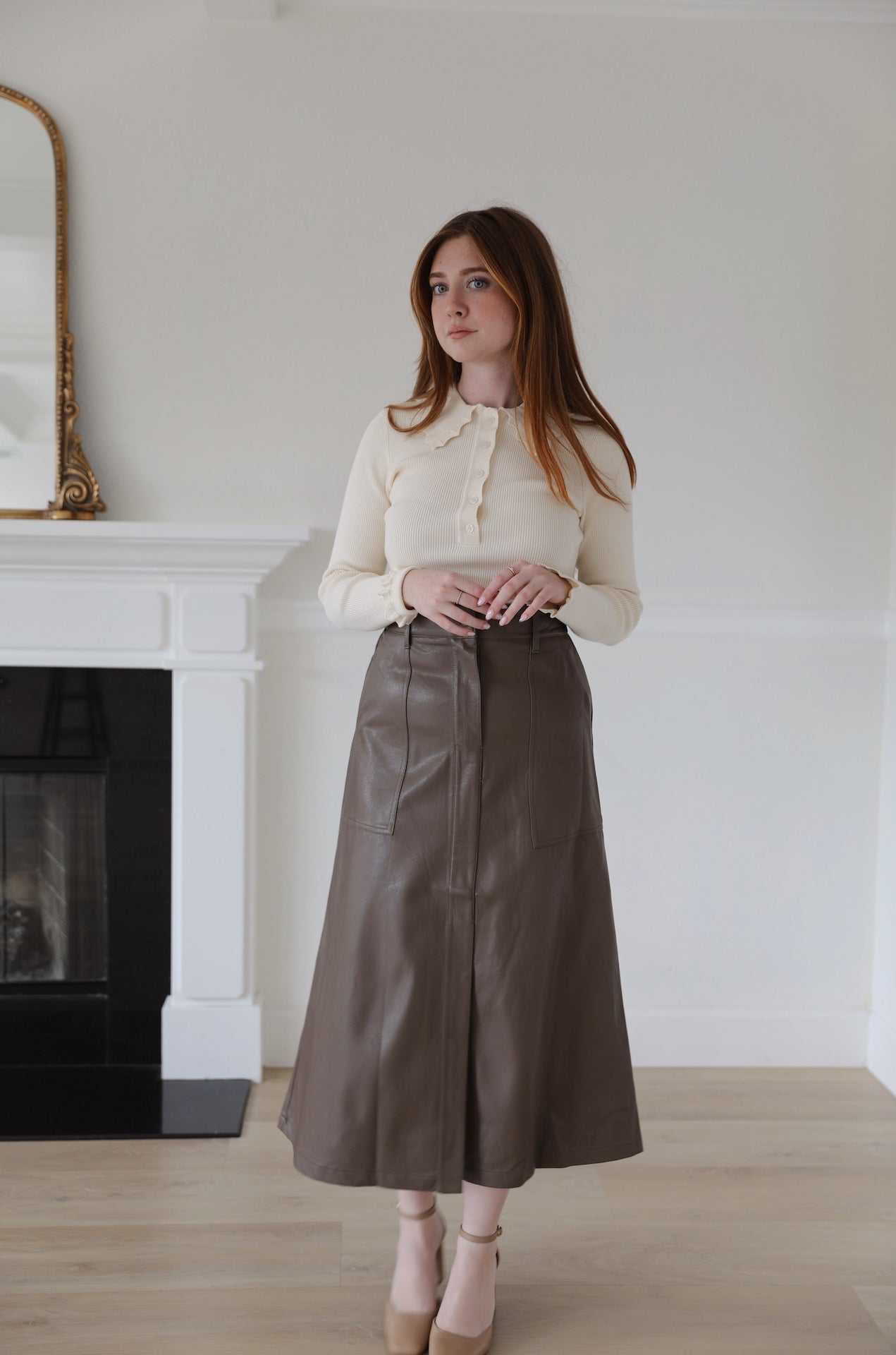 brown faux leather midi skirt that is high waisted with pockets