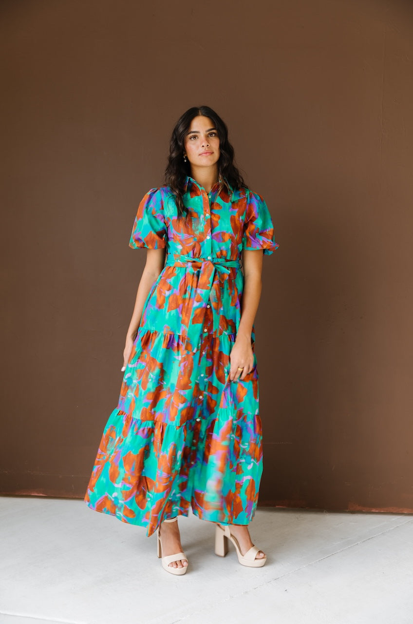 Green and brown puff sleeve button down cotton shirt dress with maxi length, waist tie and side pockets.