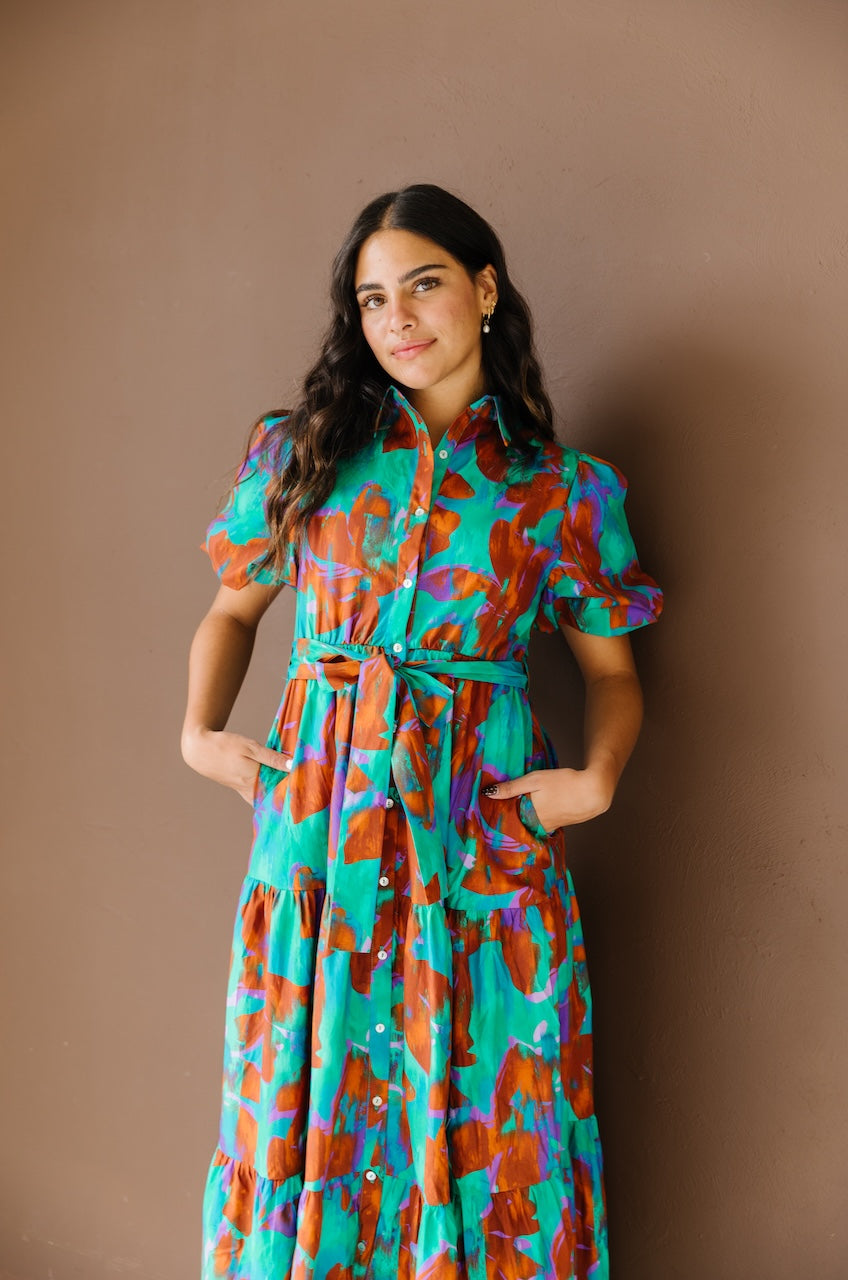 Green and brown puff sleeve button down cotton shirt dress with maxi length, waist tie and side pockets.