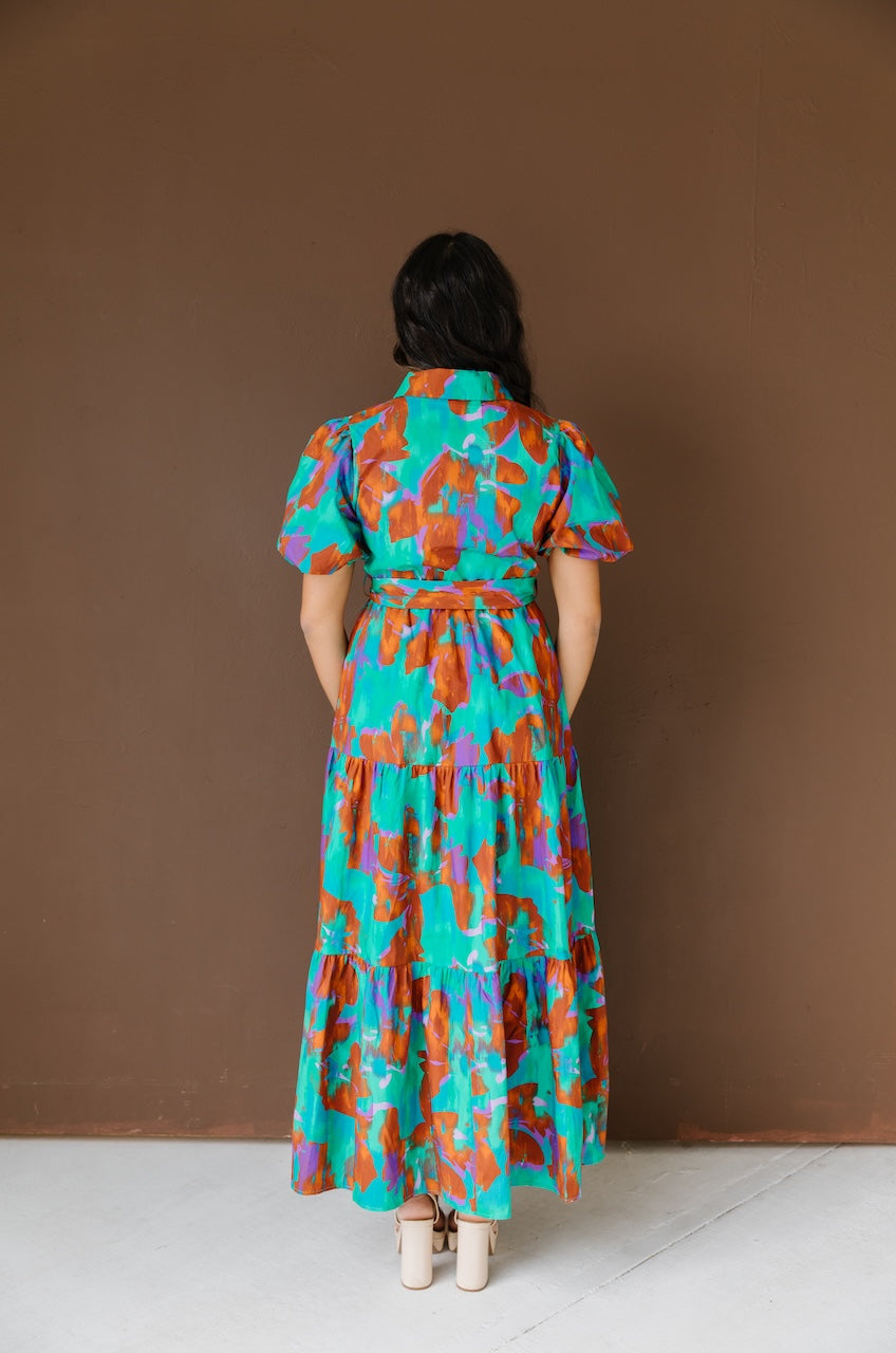 Green and brown puff sleeve button down cotton shirt dress with maxi length, waist tie and side pockets.