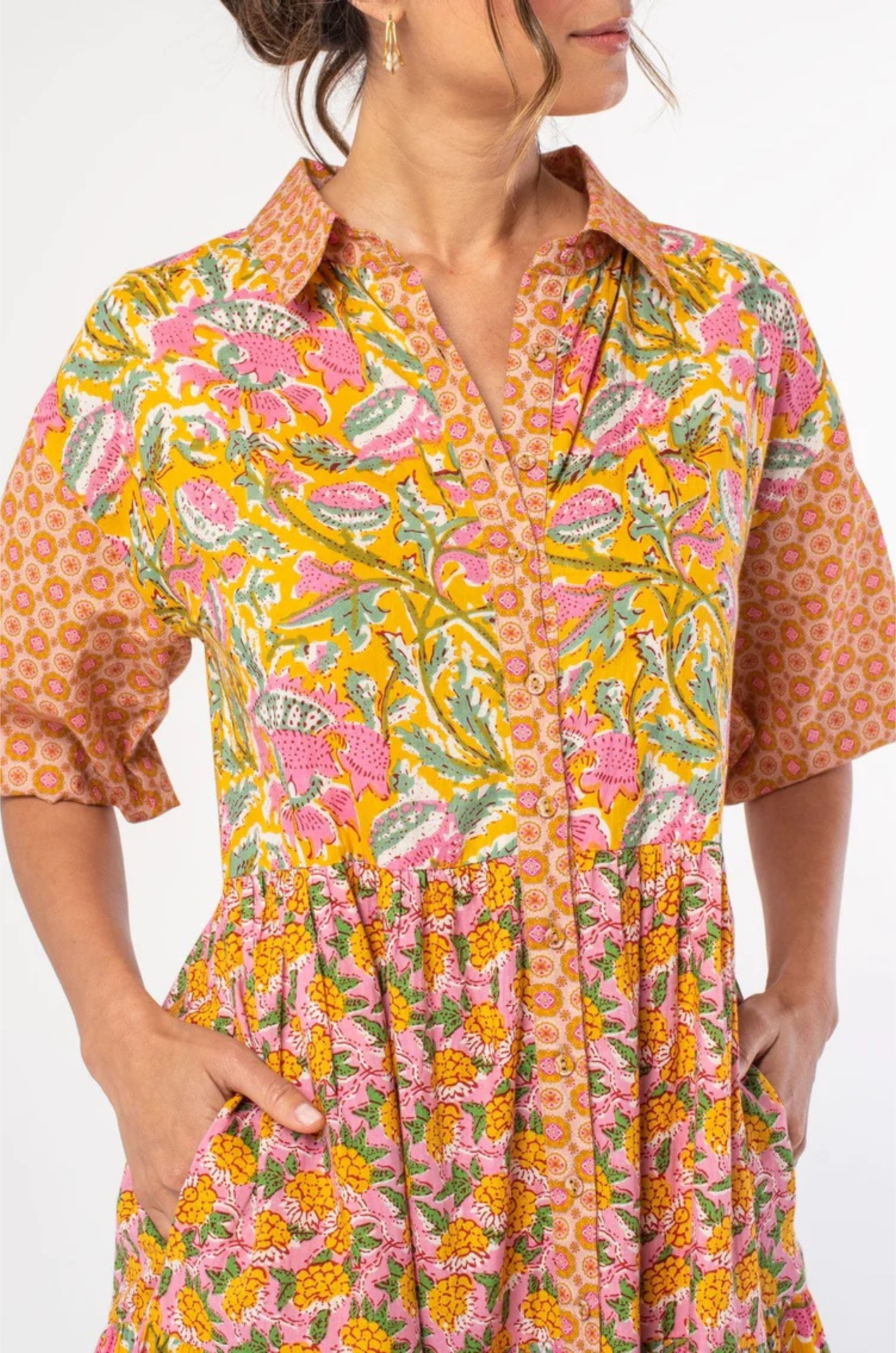 vibrant tiered maxi dress with puff sleeves and an orange and pink pattern