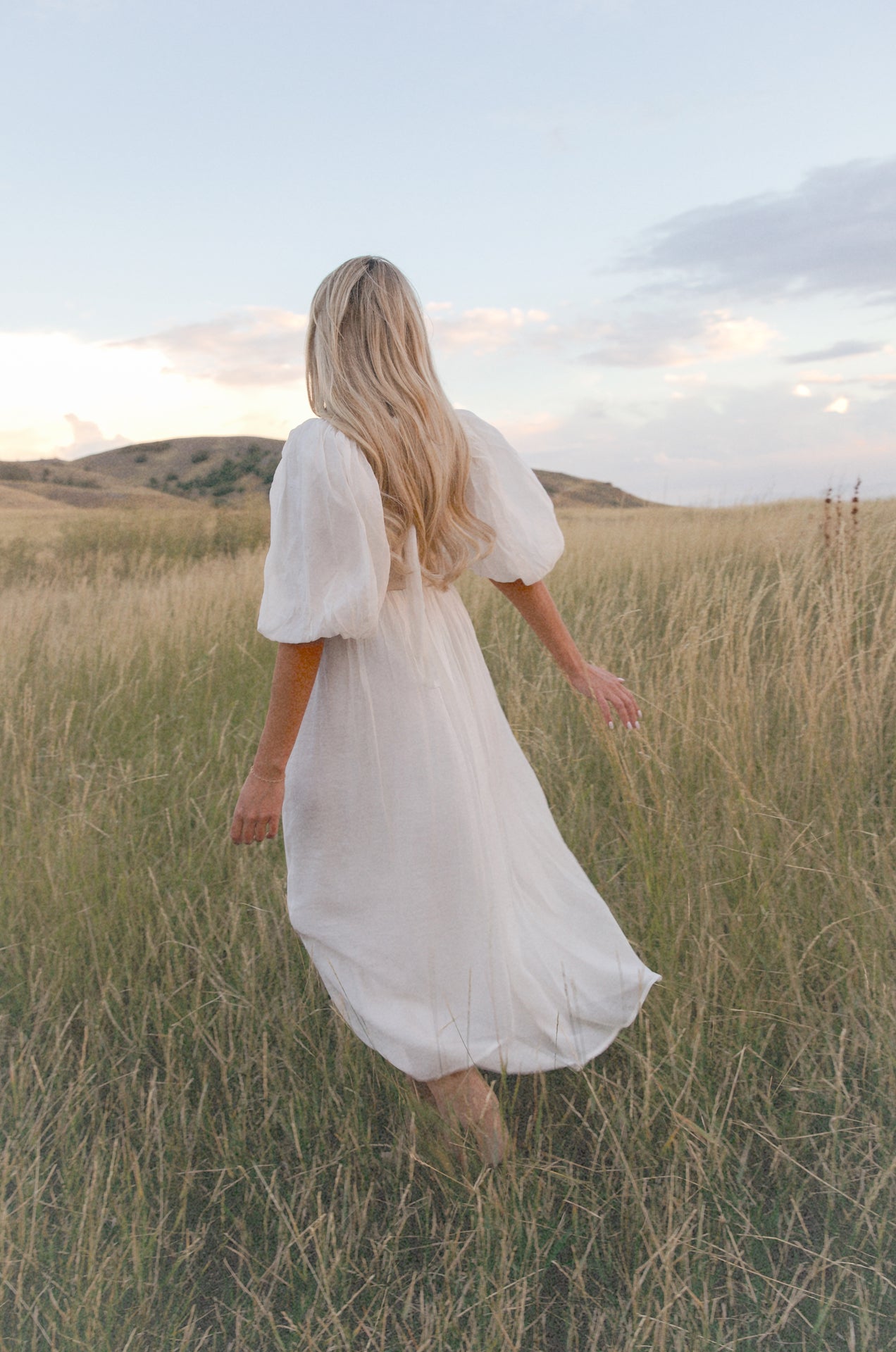 cream and white puff sleeve midi dress with a babydoll silhouette 