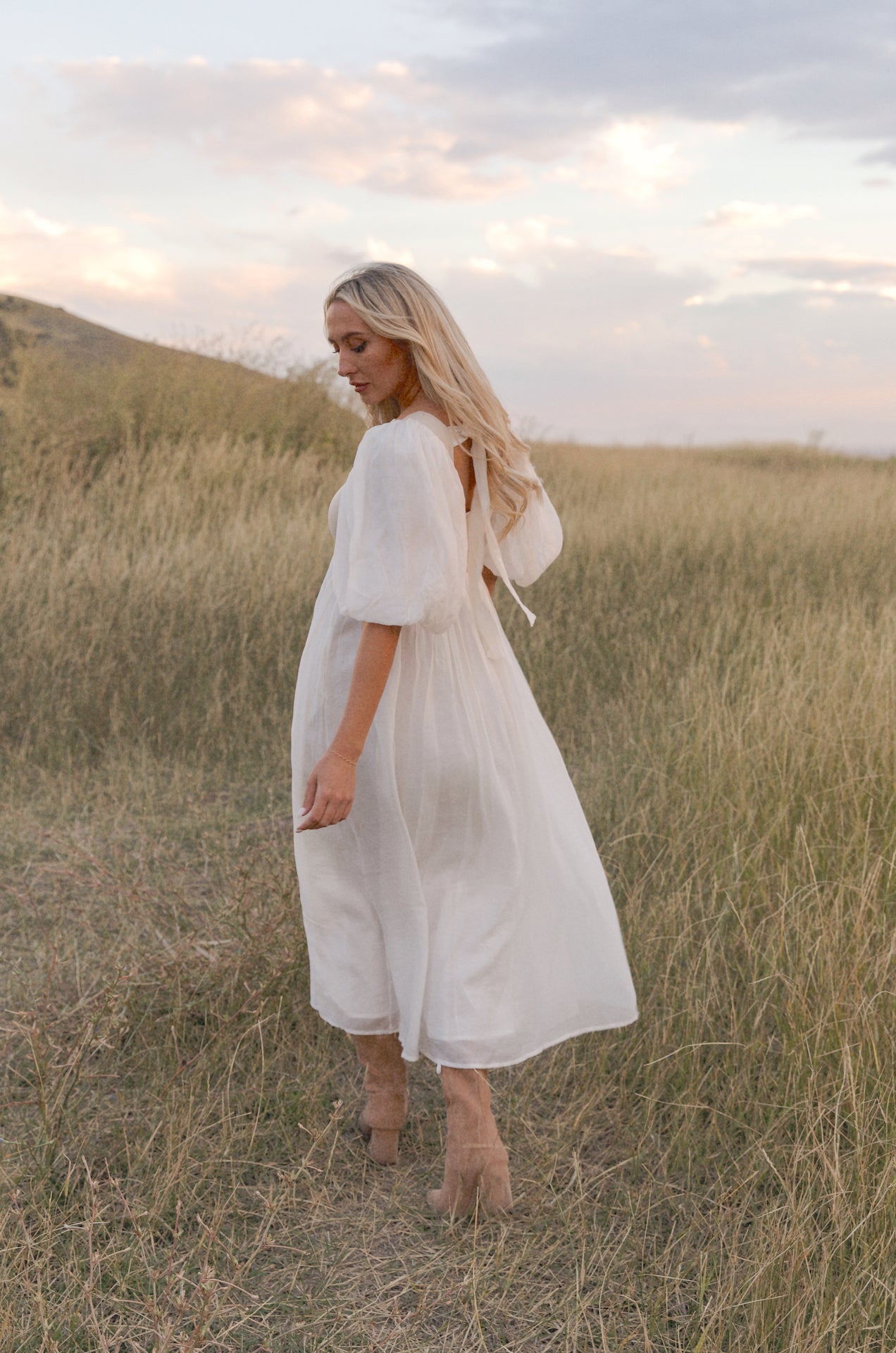 cream and white puff sleeve midi dress with a babydoll silhouette