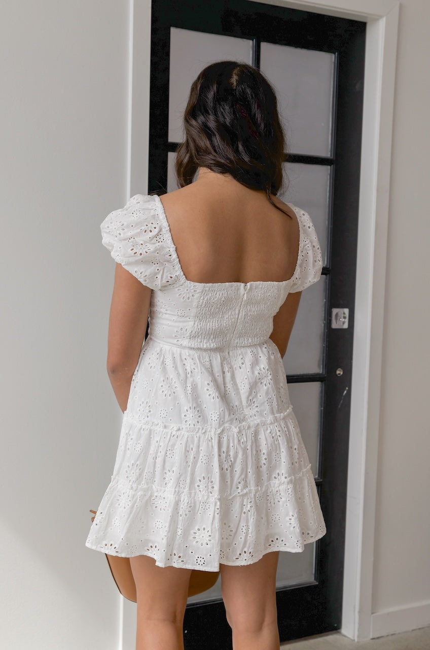 white eyelet puff sleeve tiered mini dress with a sweetheart neckline