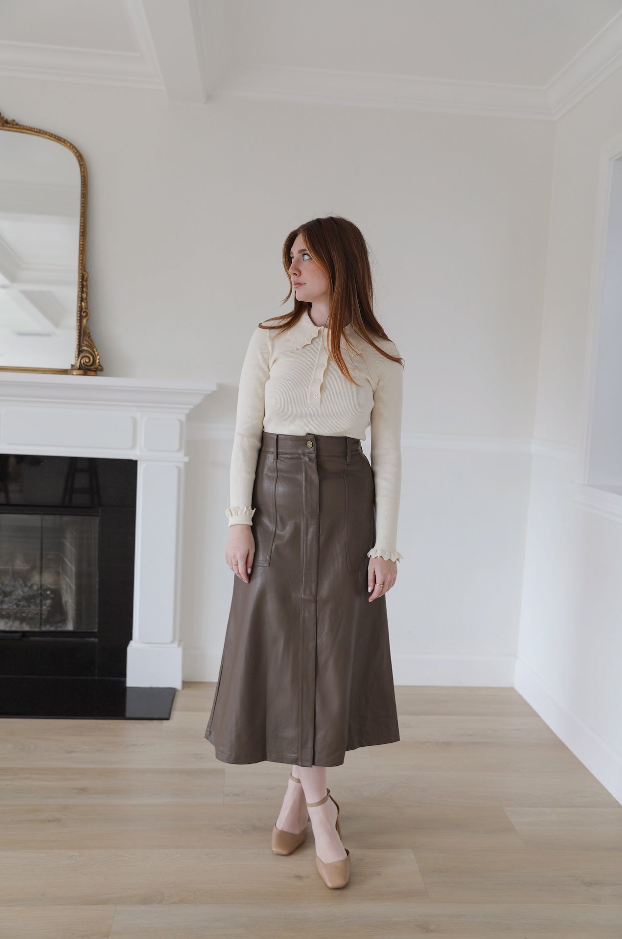 brown faux leather midi skirt that is high waisted with pockets