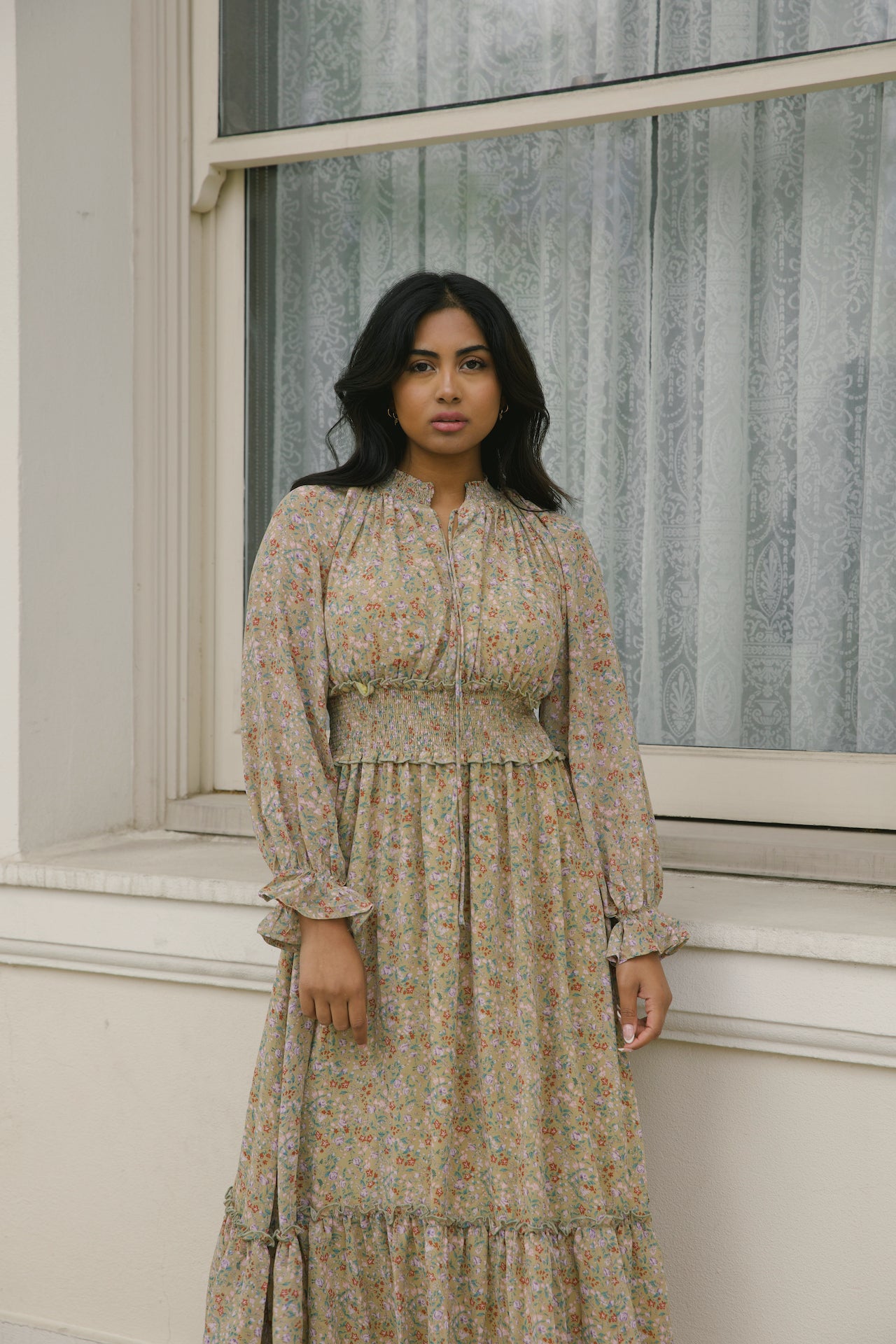 green floral midi dress with long sleeves and a smocked waistline