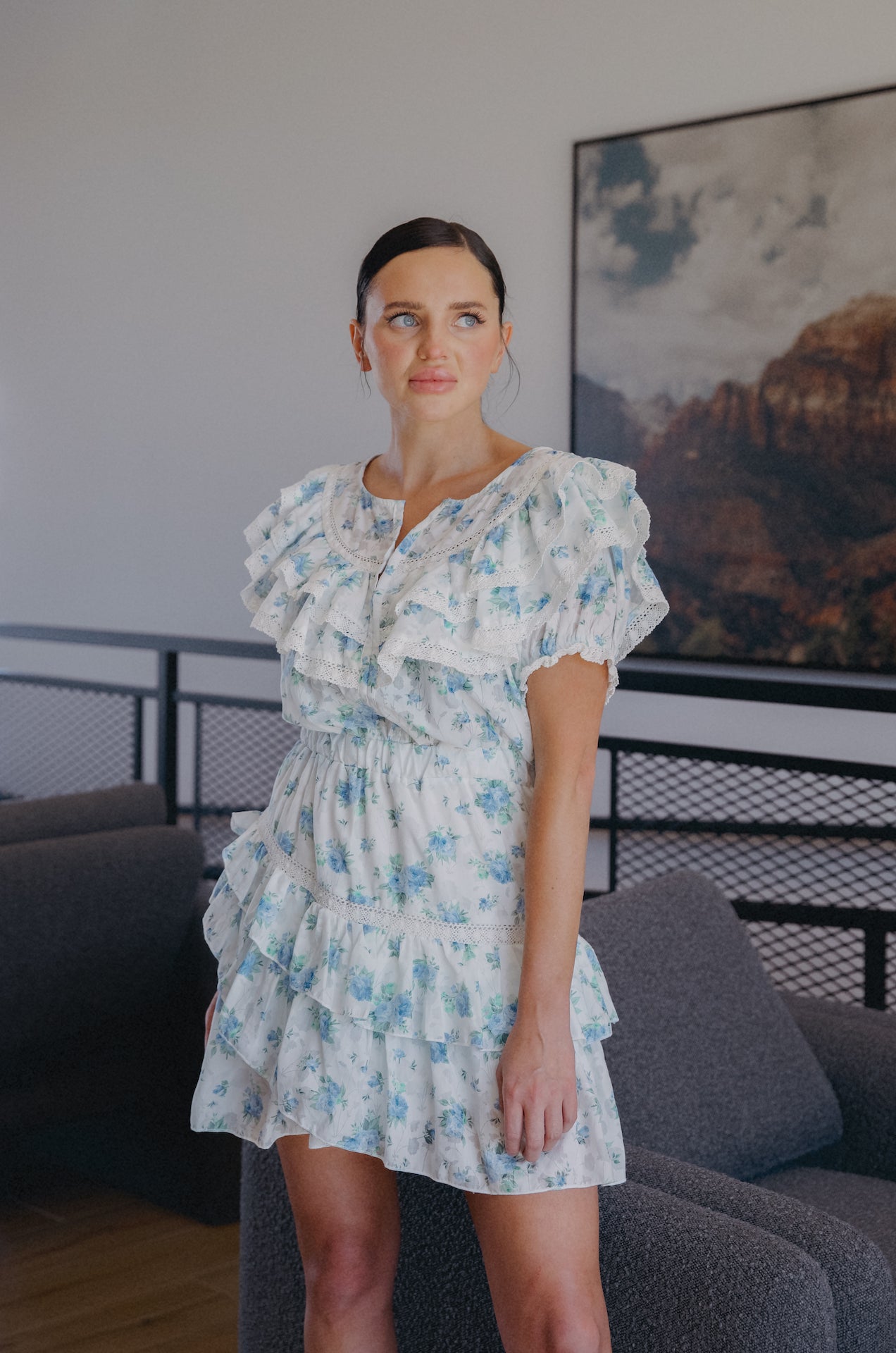 white ruffle mini dress with sleeves and blue floral print