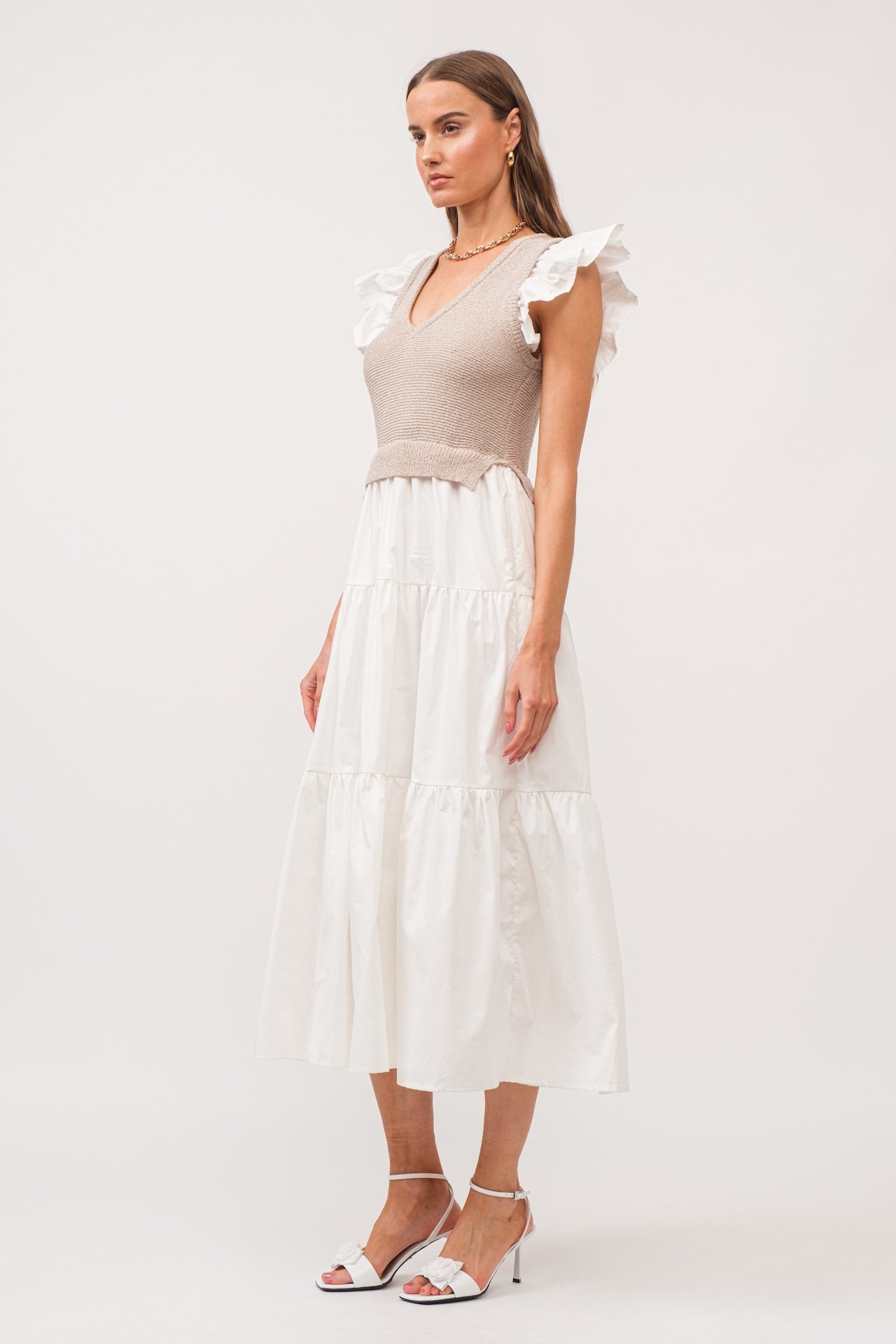 white flutter sleeve tiered midi dress with beige built in knit vest