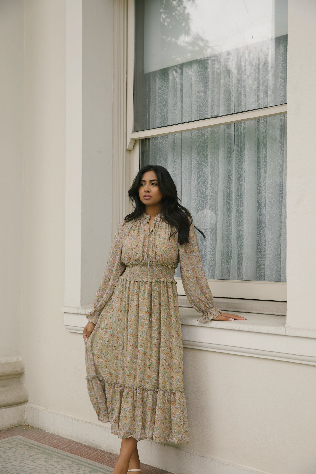 green floral midi dress with long sleeves and a smocked waistline
