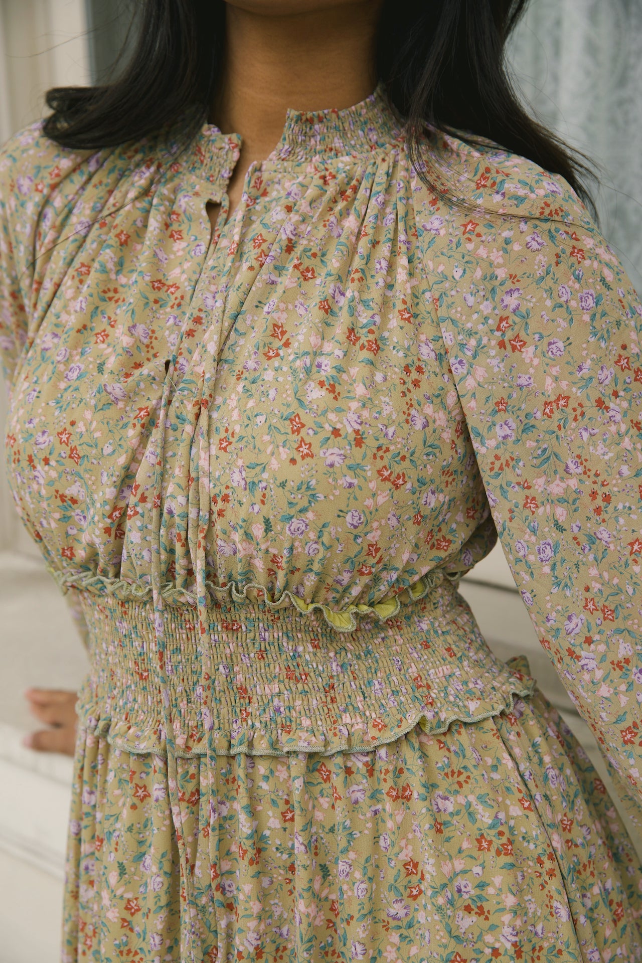 green floral midi dress with long sleeves and a smocked waistline