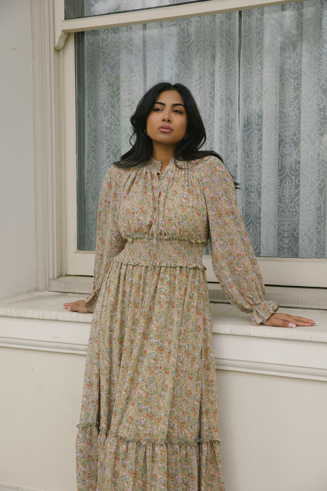green floral midi dress with long sleeves and a smocked waistline