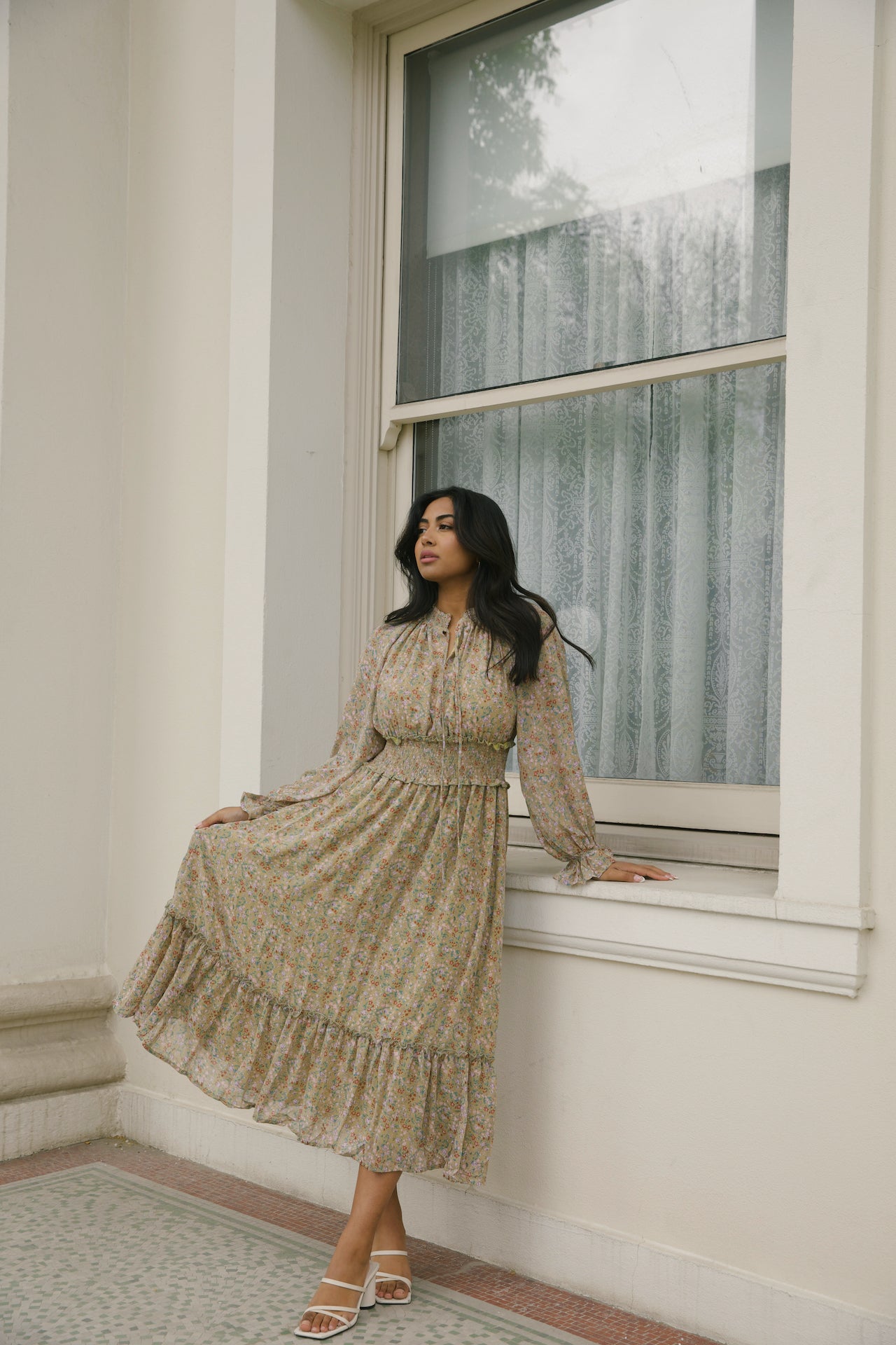 green floral midi dress with long sleeves and a smocked waistline