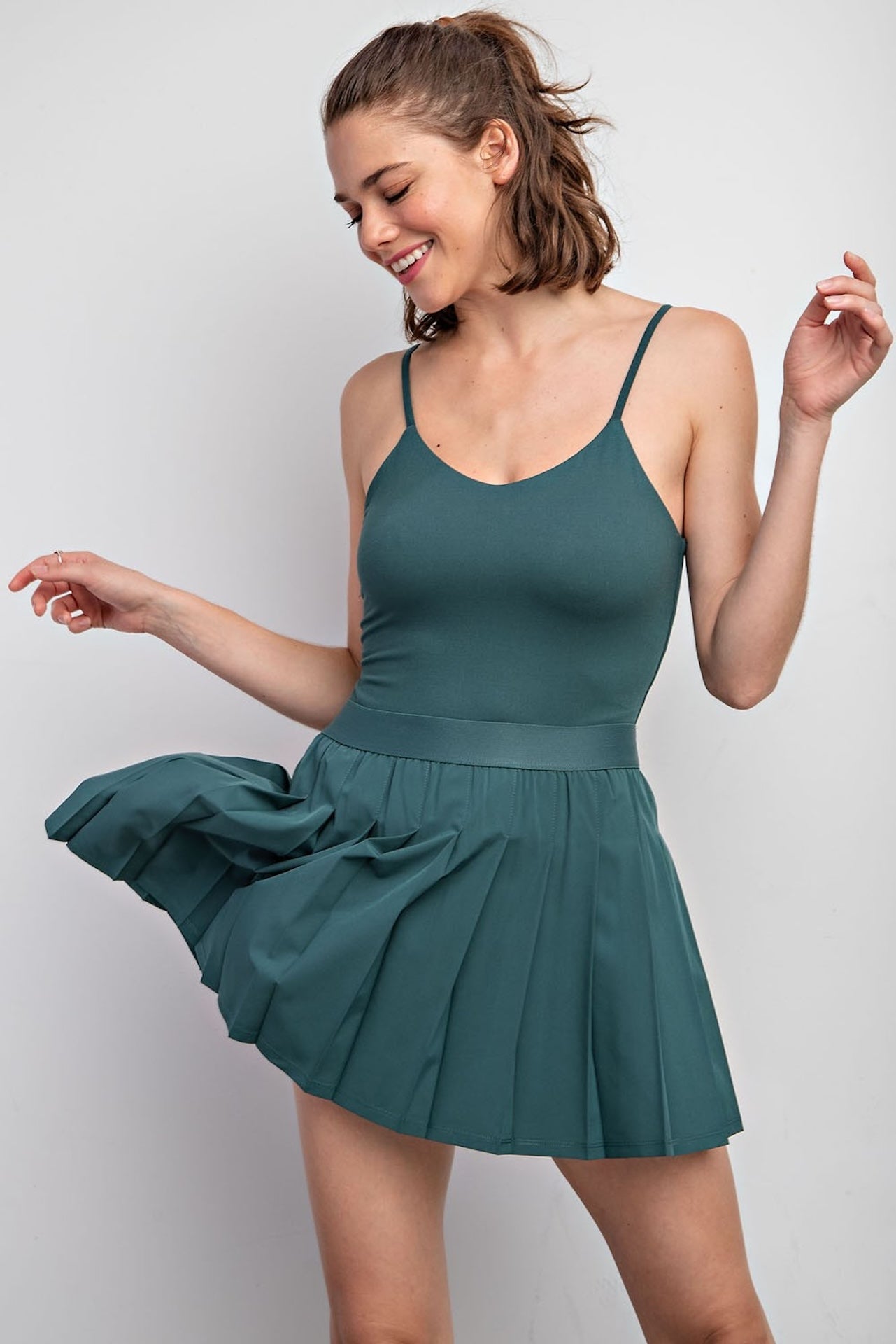 green pleated tennis mini skirt with built in shorts