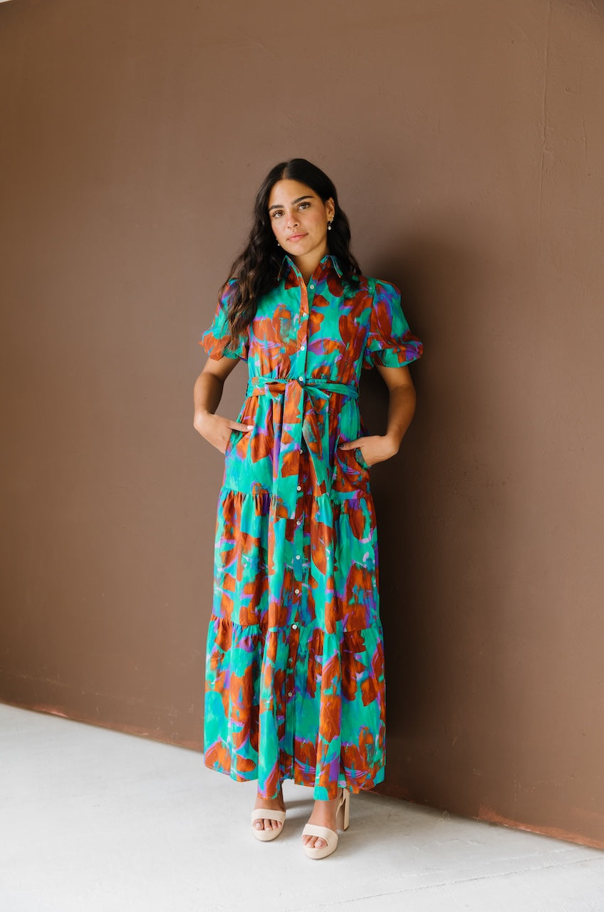 Green and brown puff sleeve button down cotton shirt dress with maxi length, waist tie and side pockets.