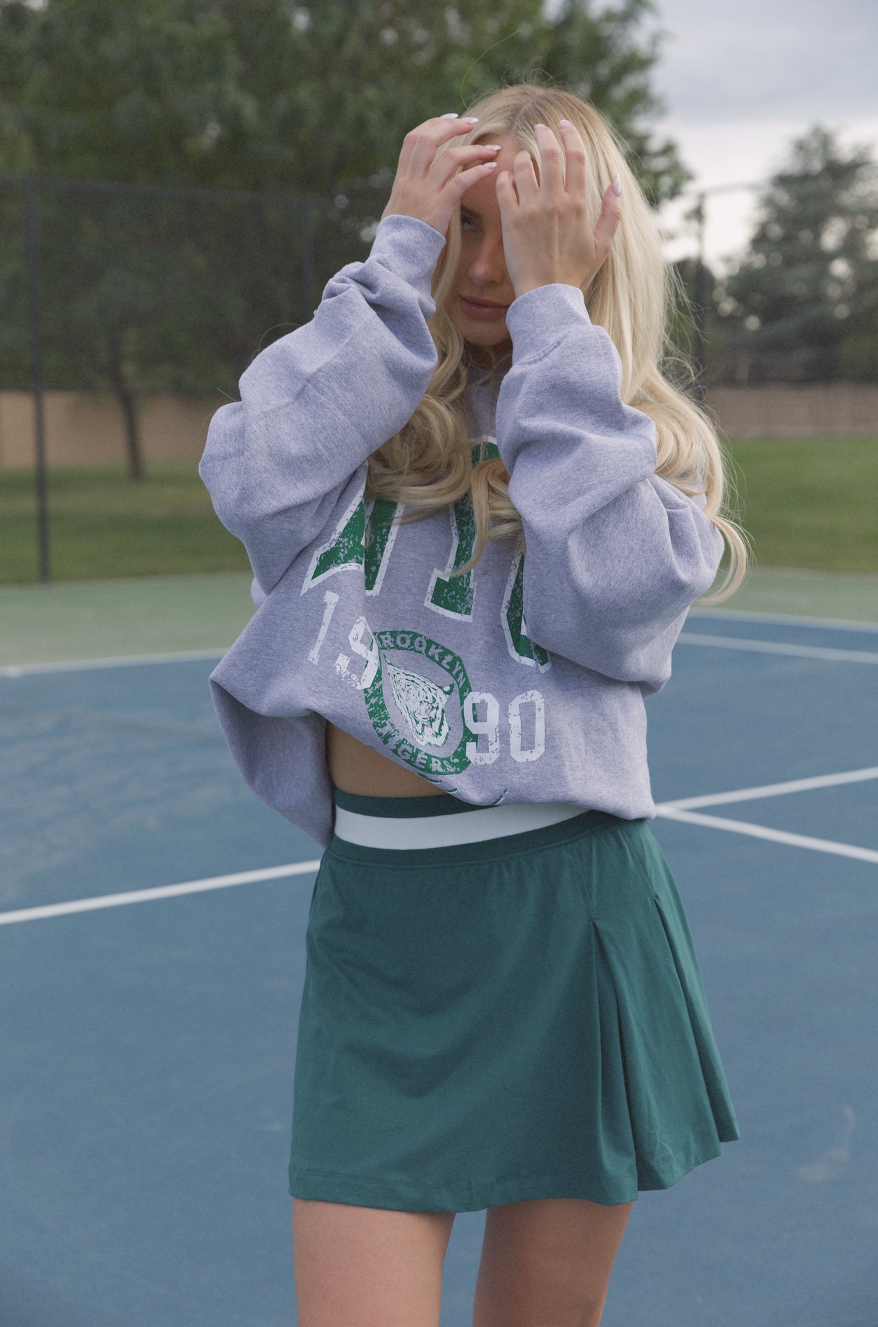 green pleated mini skirt with stretchy waist band worn for pickleball, tennis and golf