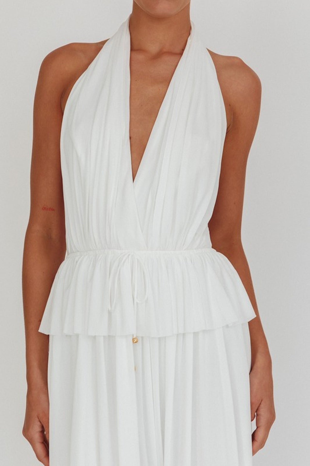 white halter maxi dress with peplum waist and open back