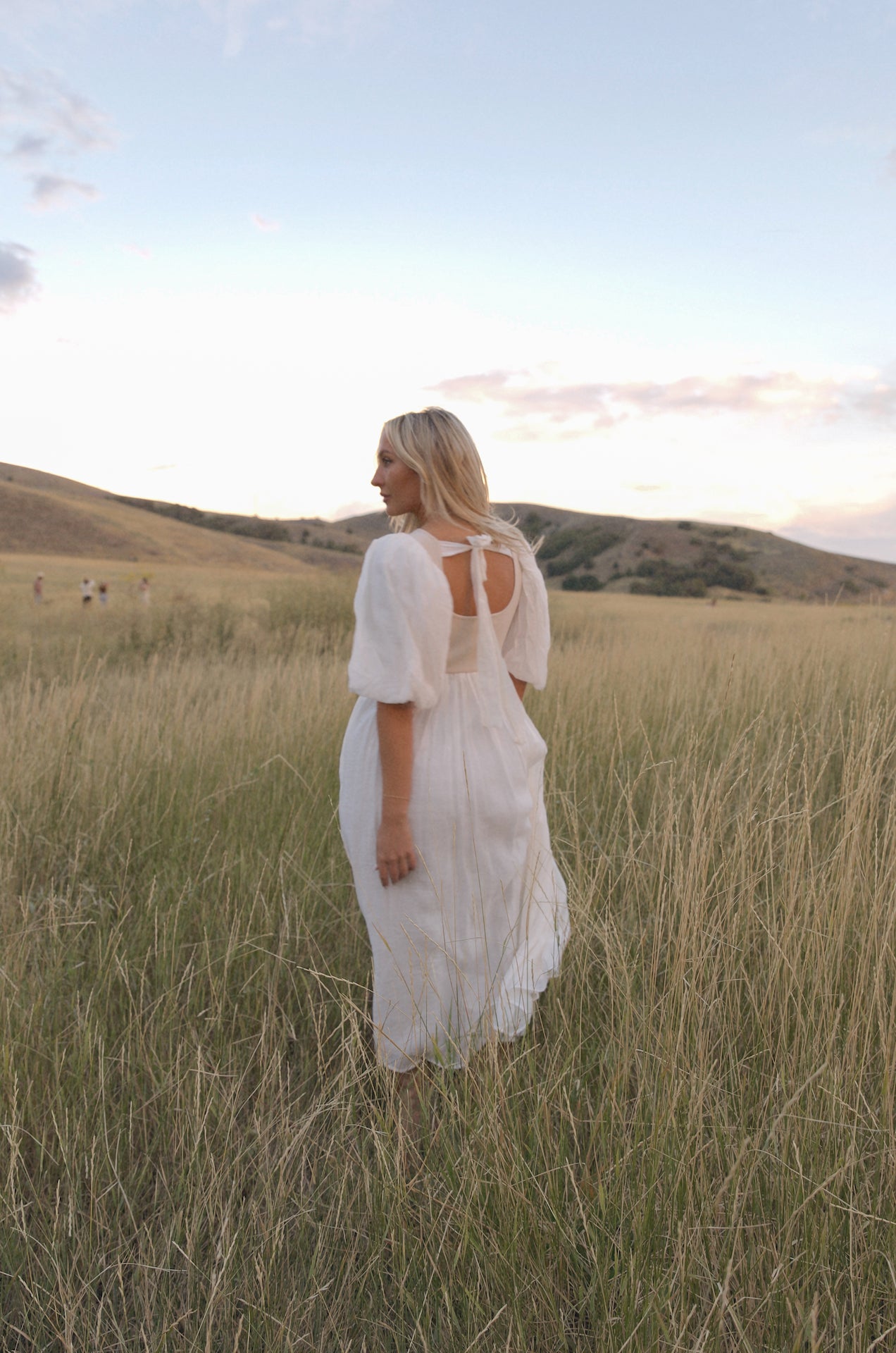 cream and white puff sleeve midi dress with a babydoll silhouette