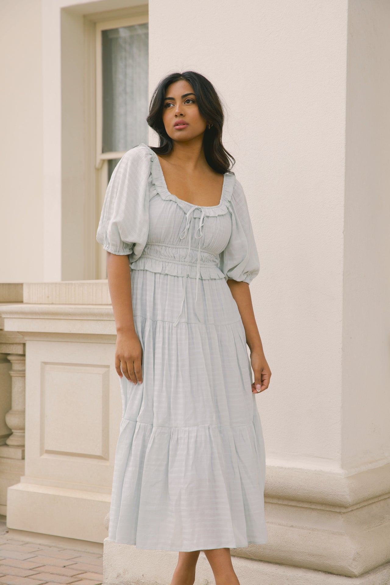 sage midi dress with puff sleeves, ruffles and a tiered midi dress style