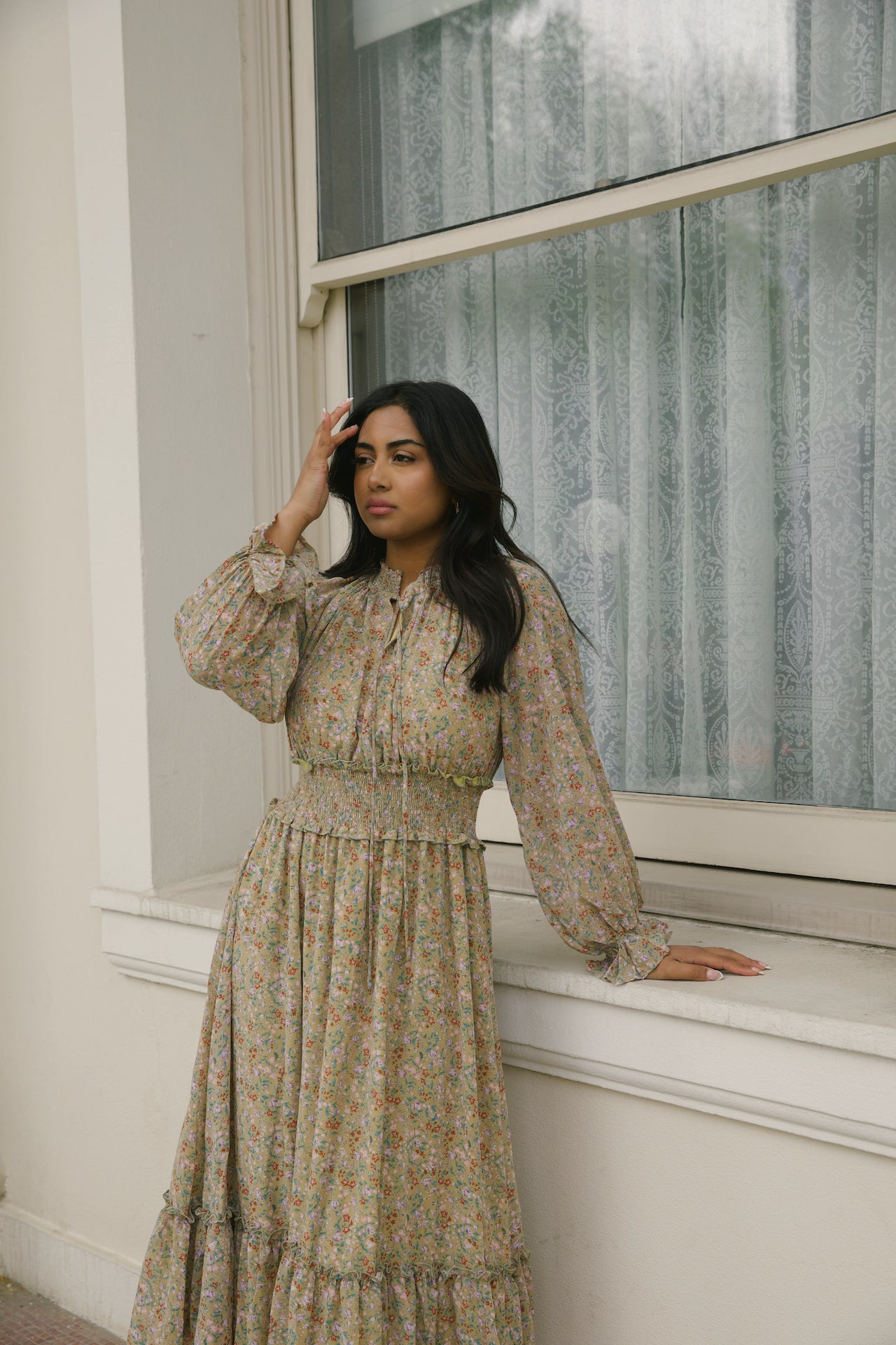 green floral midi dress with long sleeves and a smocked waistline