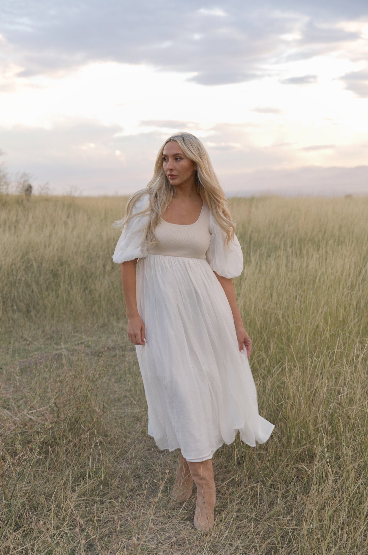 cream and white puff sleeve midi dress with a babydoll silhouette