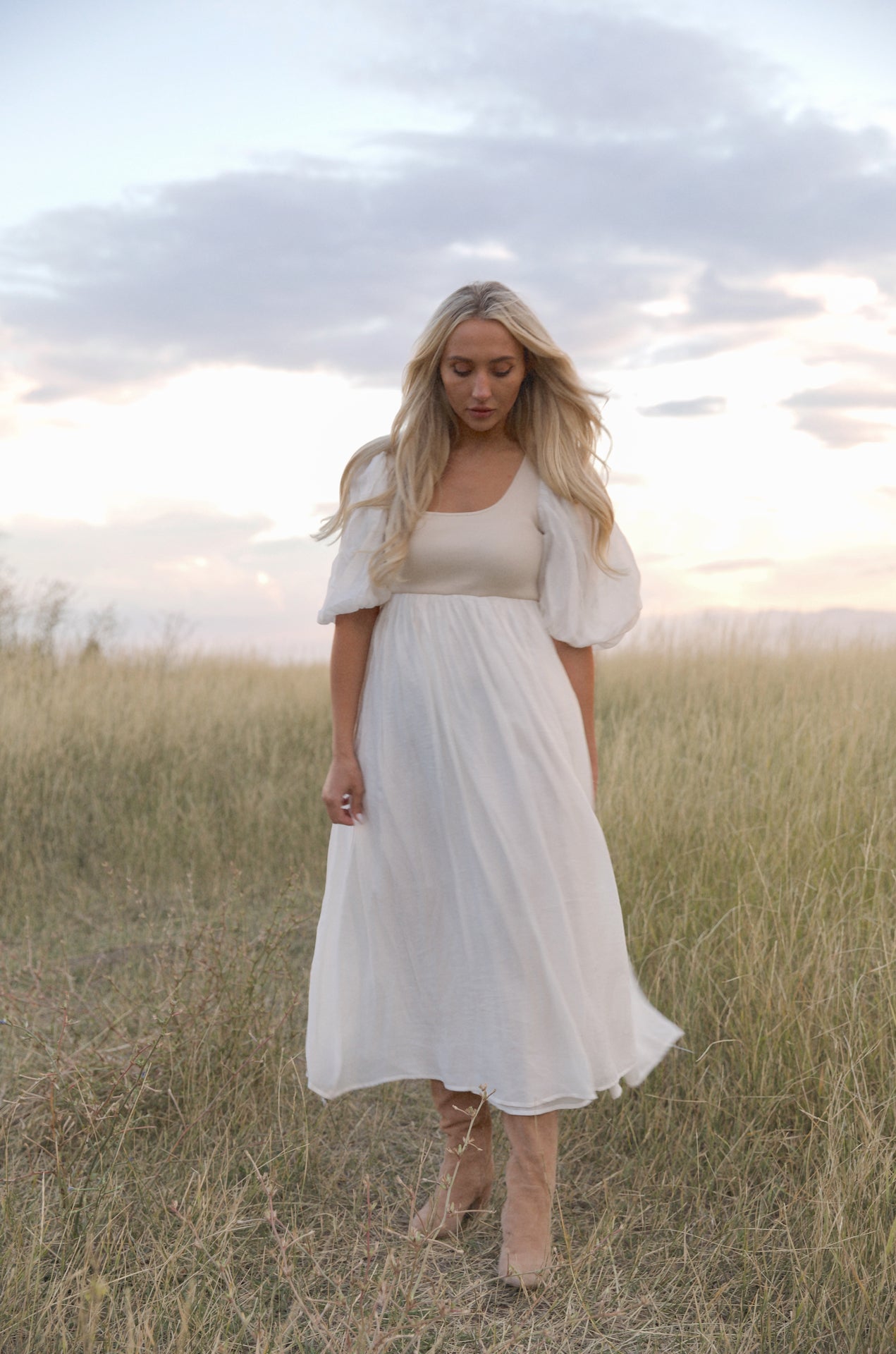 cream and white puff sleeve midi dress with a babydoll silhouette