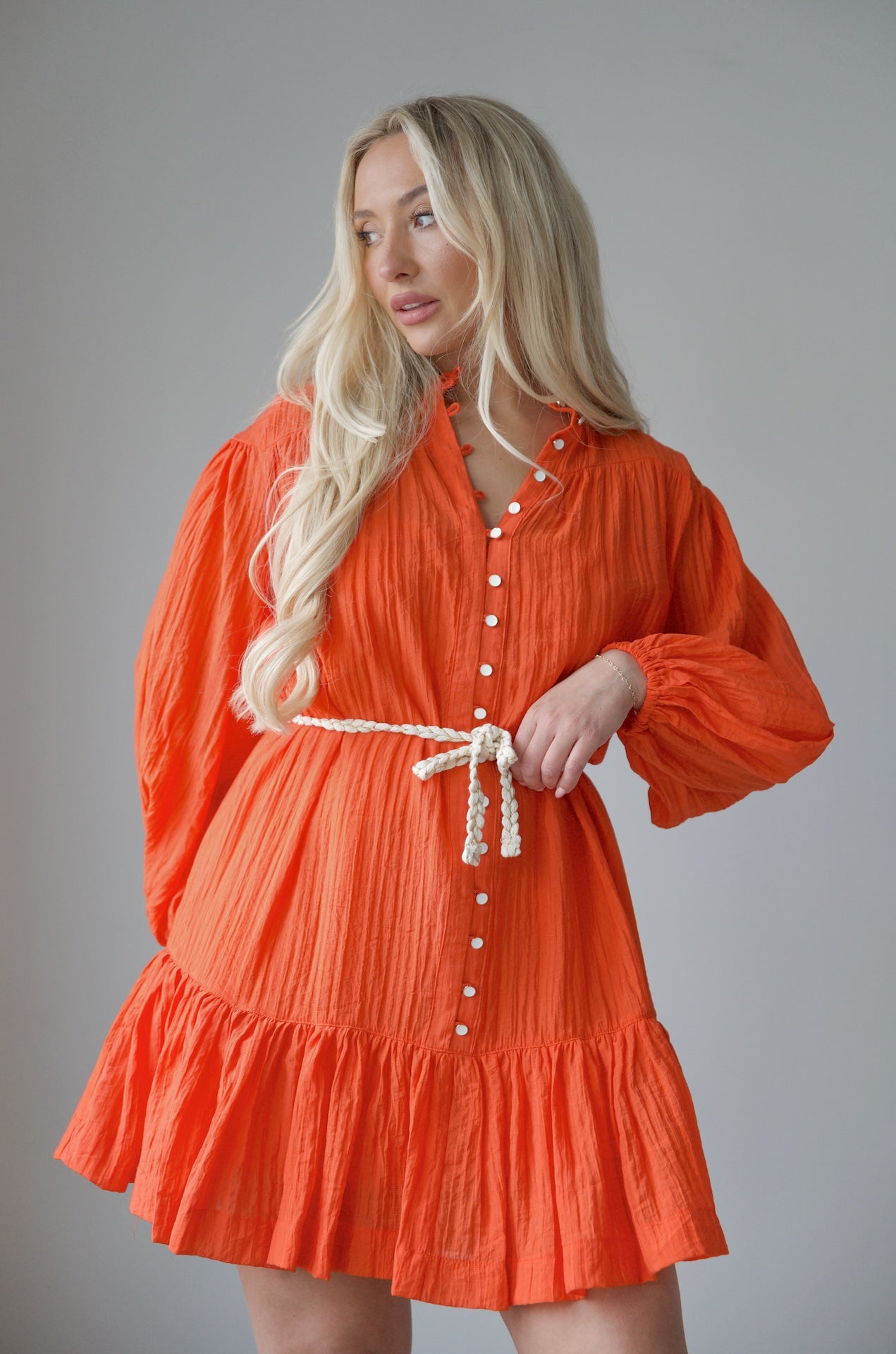 orange long sleeve mini dress with a braided belt