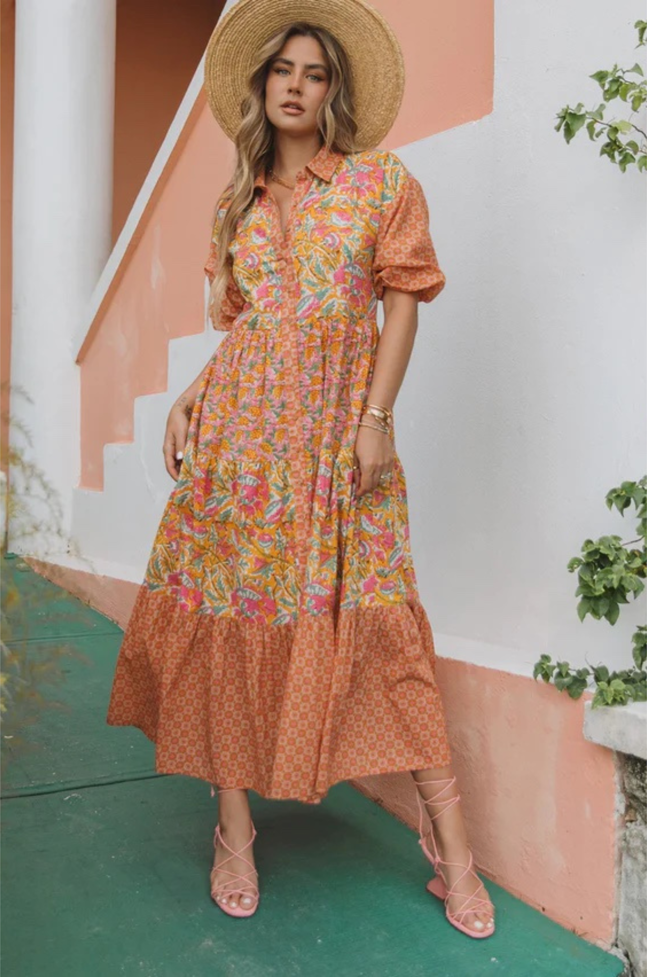 vibrant tiered maxi dress with puff sleeves and an orange and pink pattern