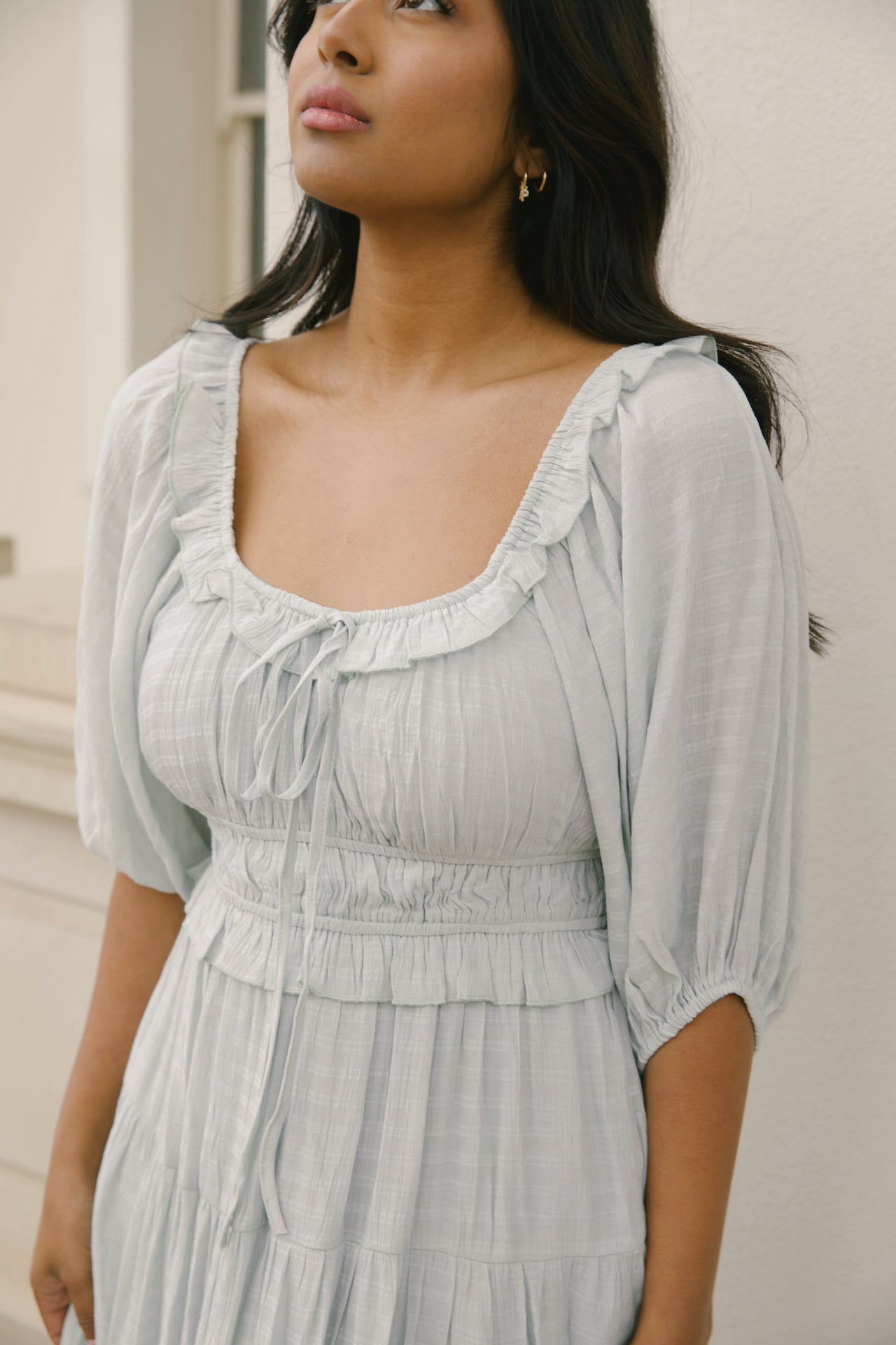 sage midi dress with puff sleeves, ruffles and a tiered midi dress style