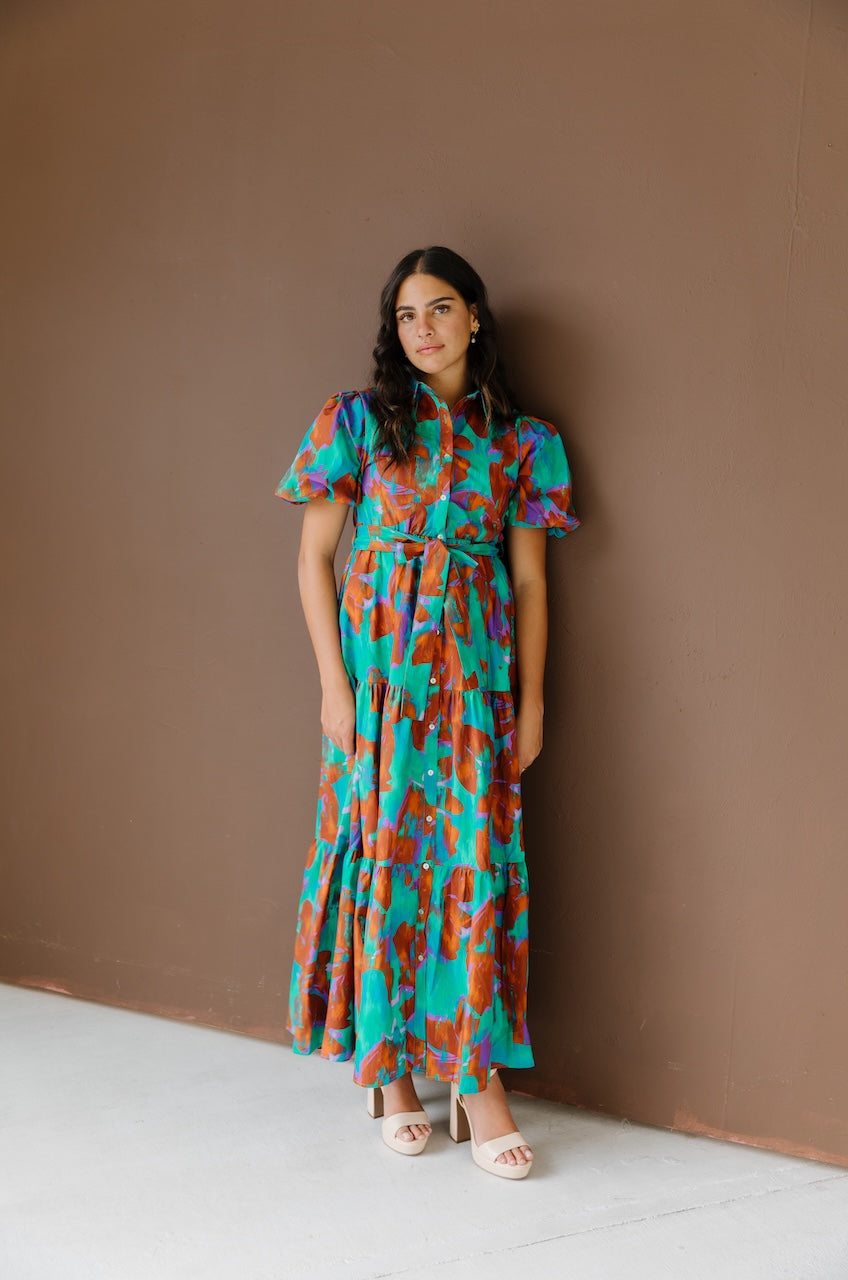 Green and brown puff sleeve button down cotton shirt dress with maxi length, waist tie and side pockets.