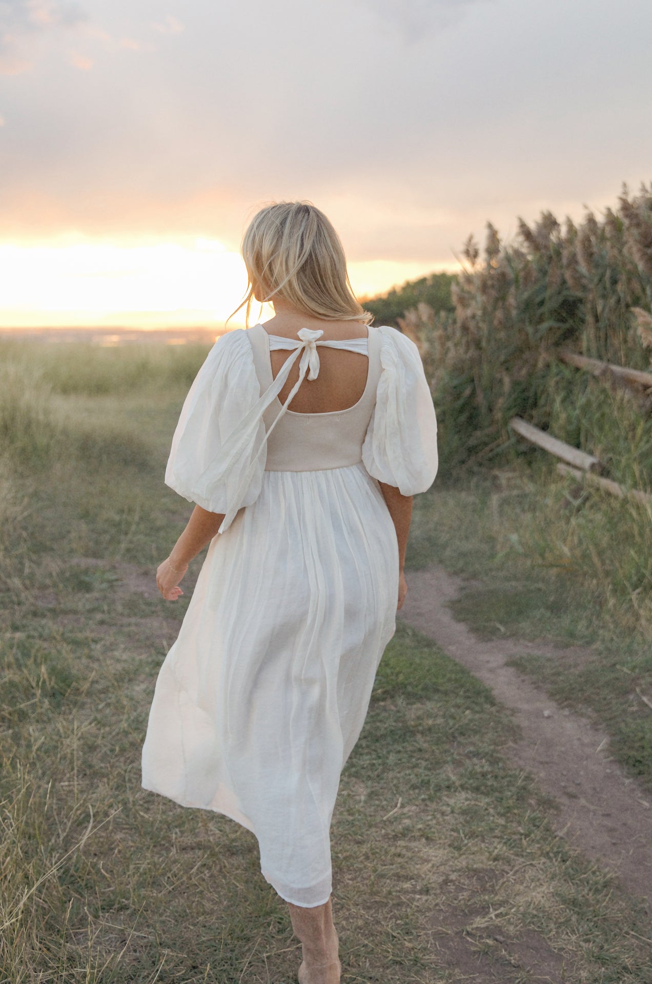 cream and white puff sleeve midi dress with a babydoll silhouette