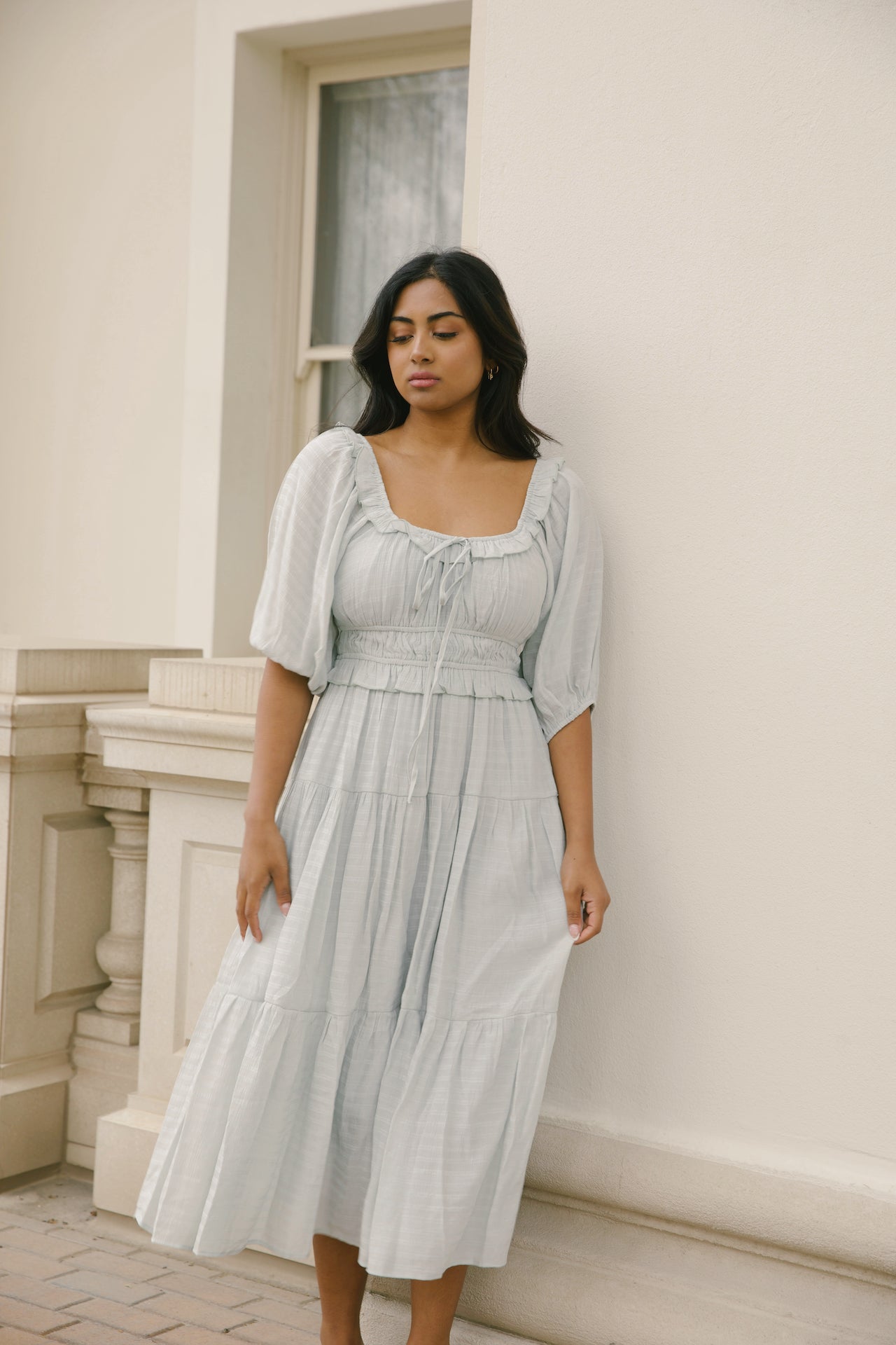 sage midi dress with puff sleeves, ruffles and a tiered midi dress style