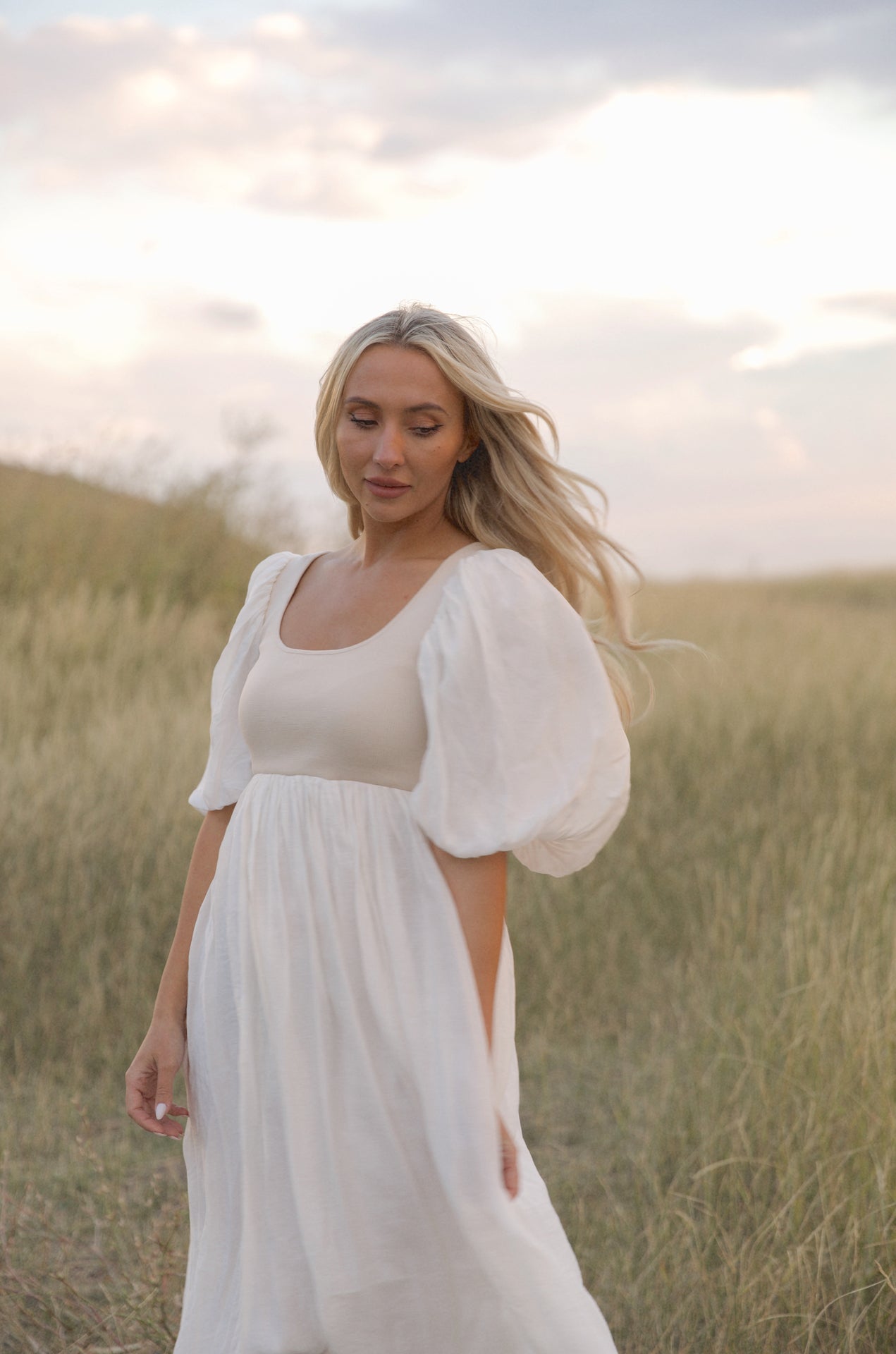 cream and white puff sleeve midi dress with a babydoll silhouette