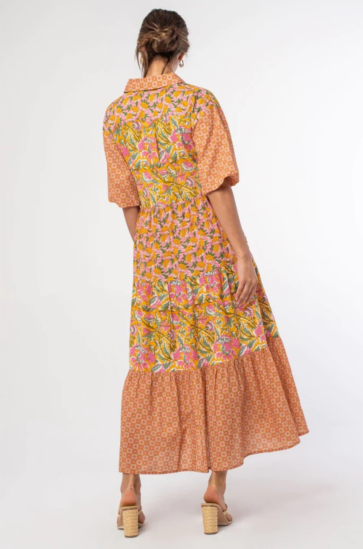 vibrant tiered maxi dress with puff sleeves and an orange and pink pattern