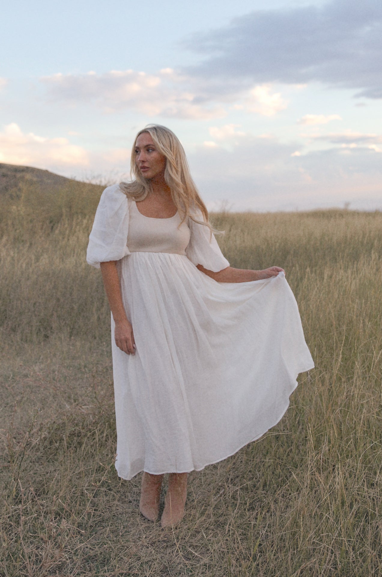 cream and white puff sleeve midi dress with a babydoll silhouette