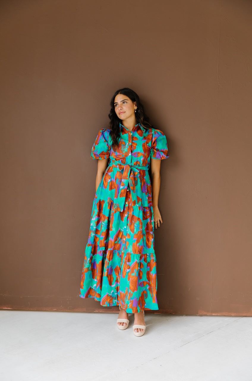 Green and brown puff sleeve button down cotton shirt dress with maxi length, waist tie and side pockets.