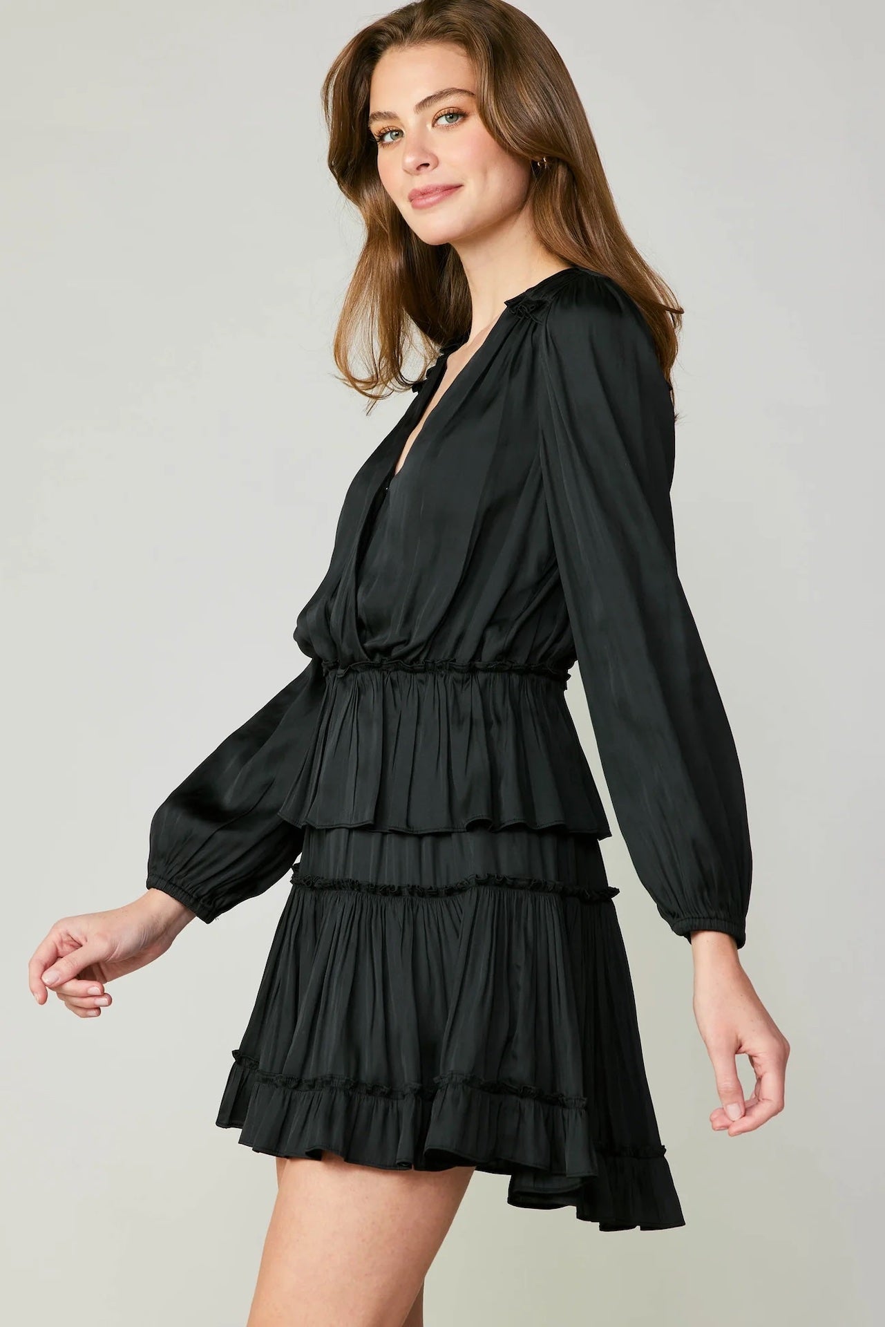 black tiered mini dress with long sleeves and pleated detail