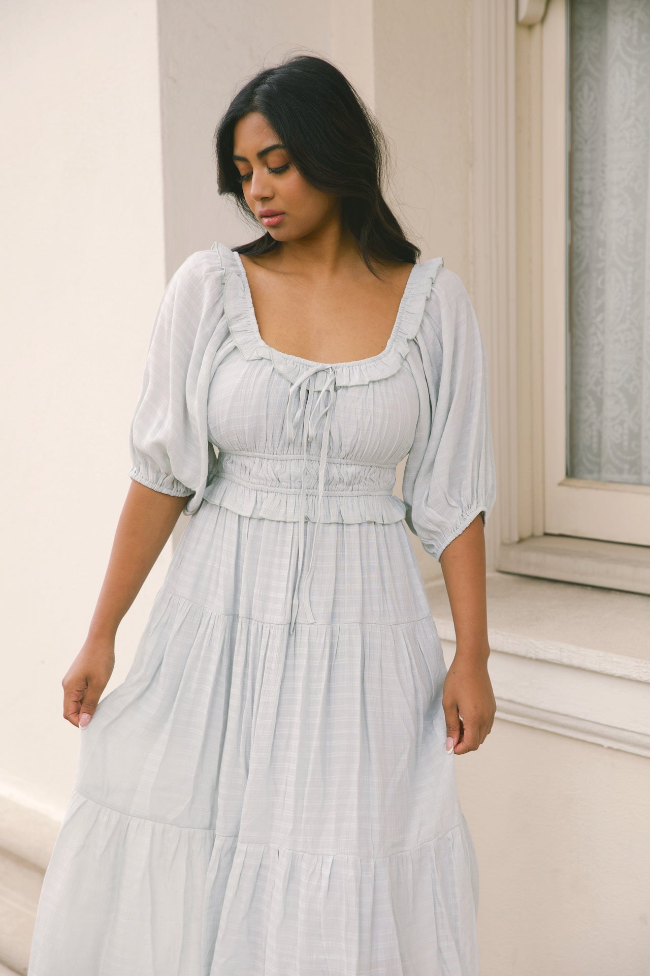 sage midi dress with puff sleeves, ruffles and a tiered midi dress style