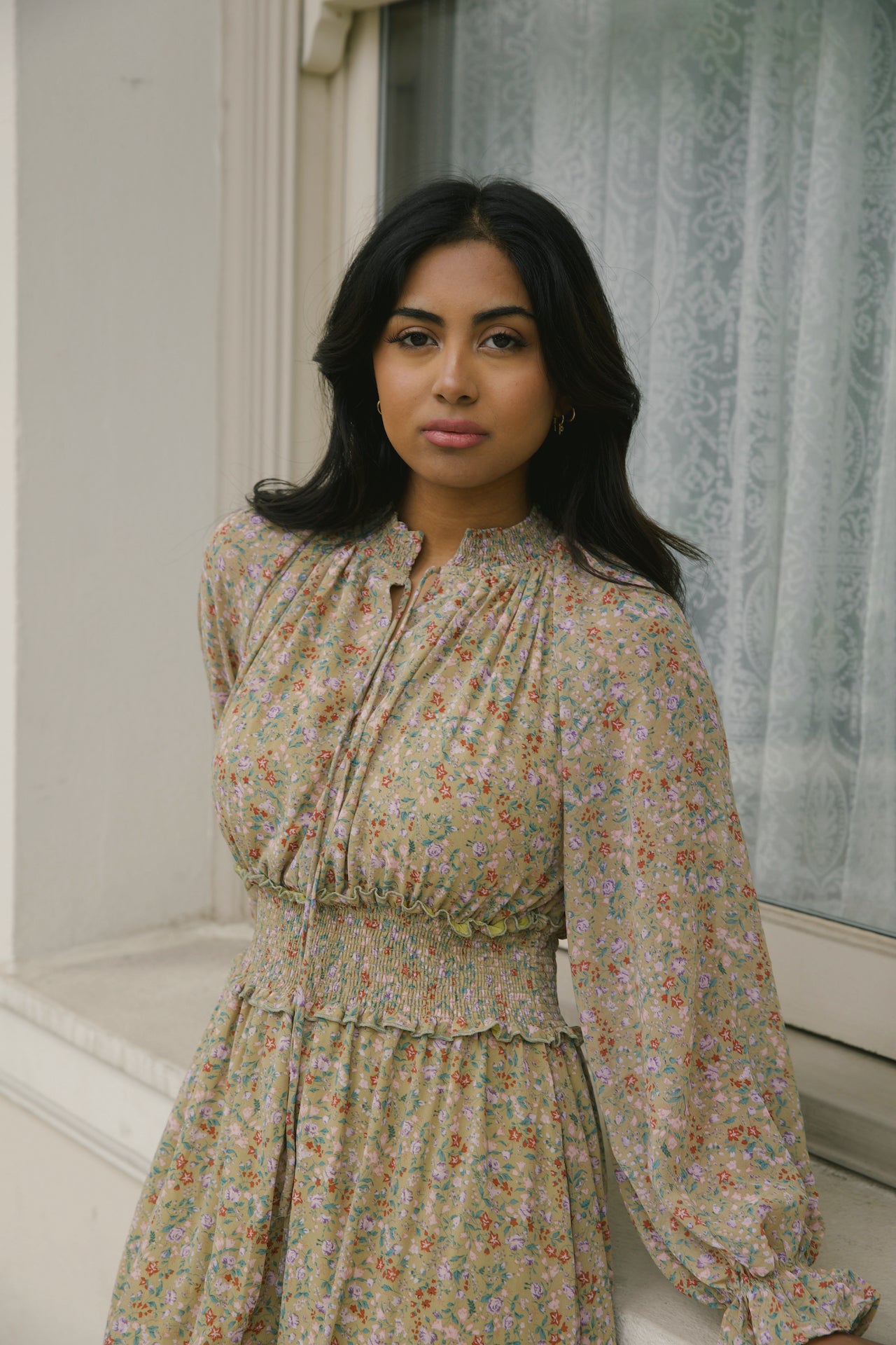 green floral midi dress with long sleeves and a smocked waistline