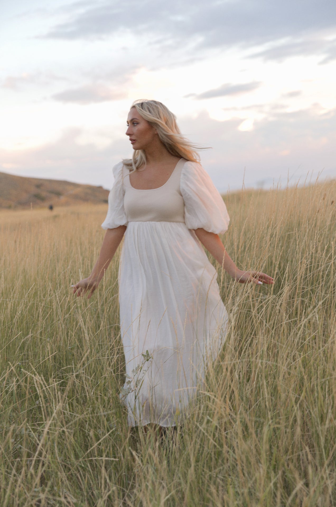 cream and white puff sleeve midi dress with a babydoll silhouette