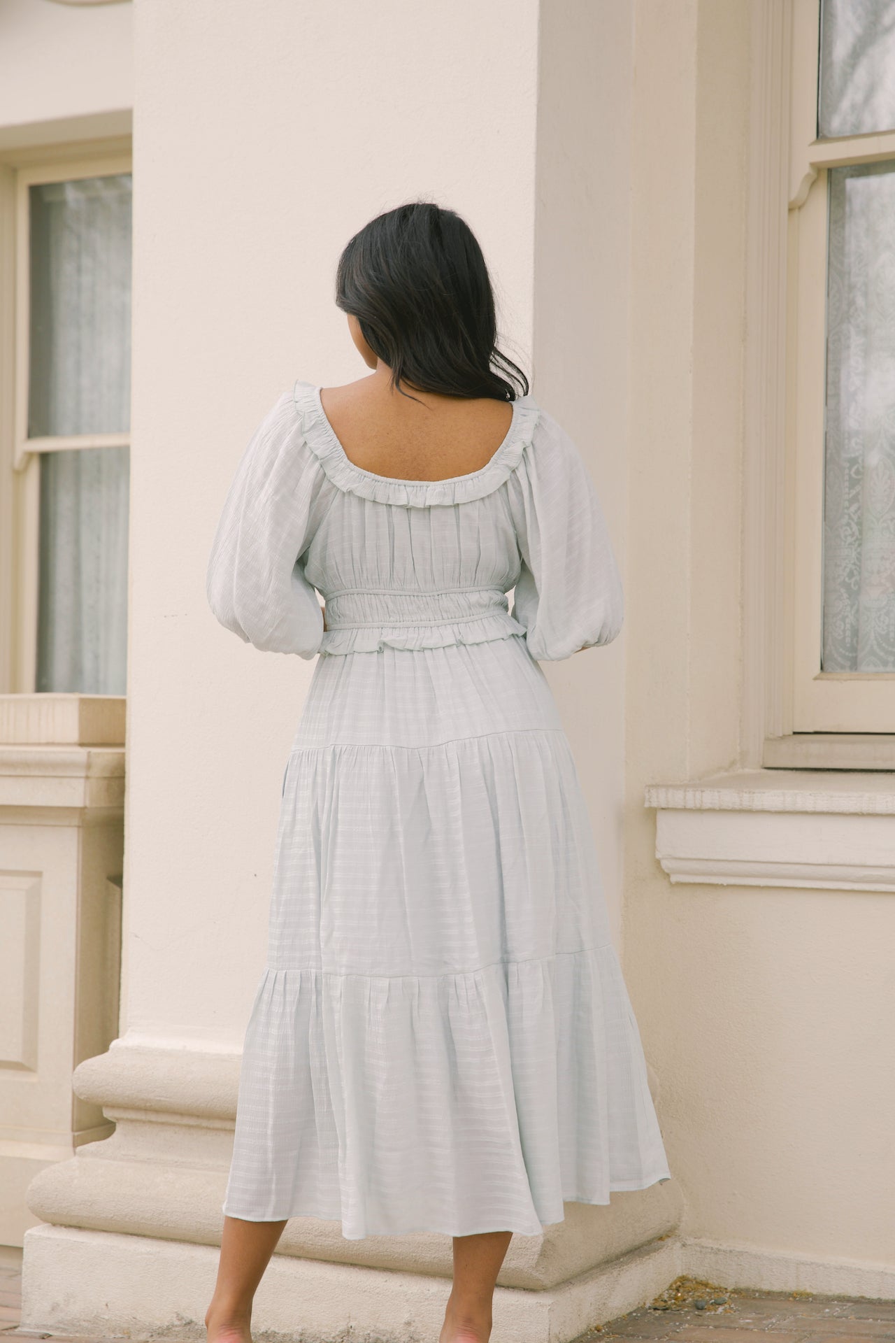 sage midi dress with puff sleeves, ruffles and a tiered midi dress style