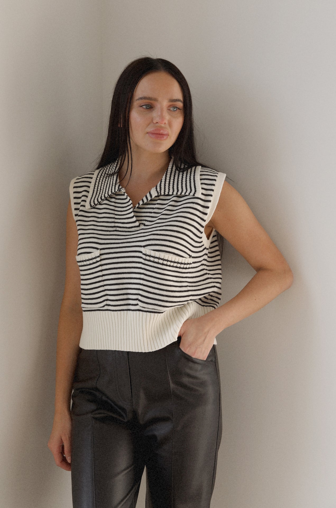 black and white striped sweater vest that is collared with pockets