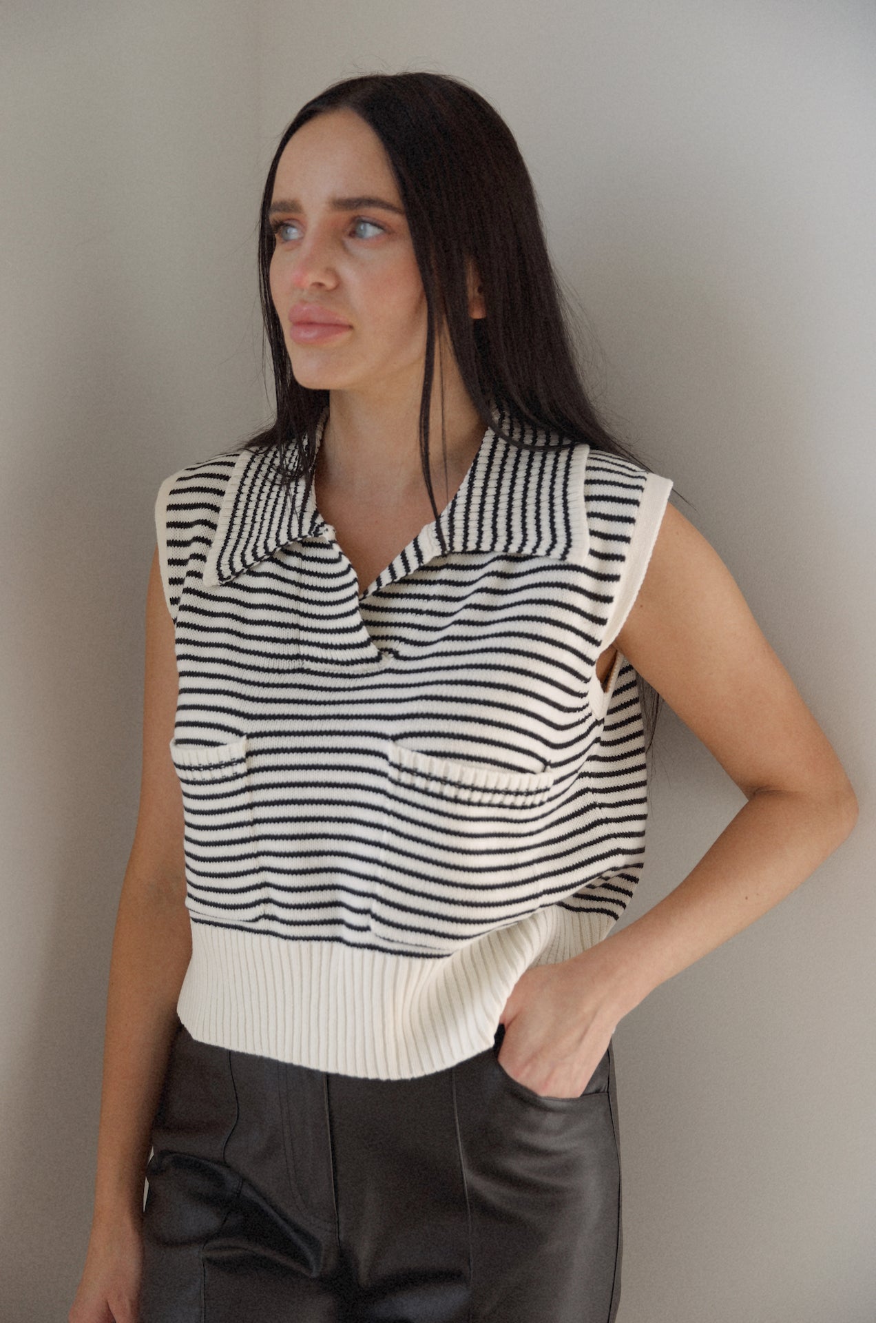 black and white striped sweater vest that is collared with pockets