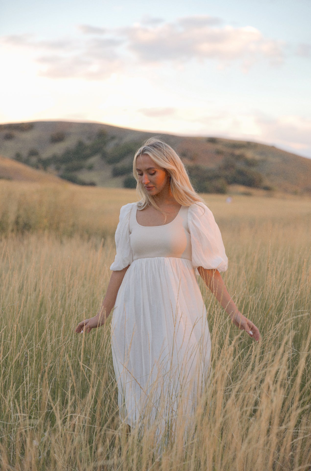 cream and white puff sleeve midi dress with a babydoll silhouette